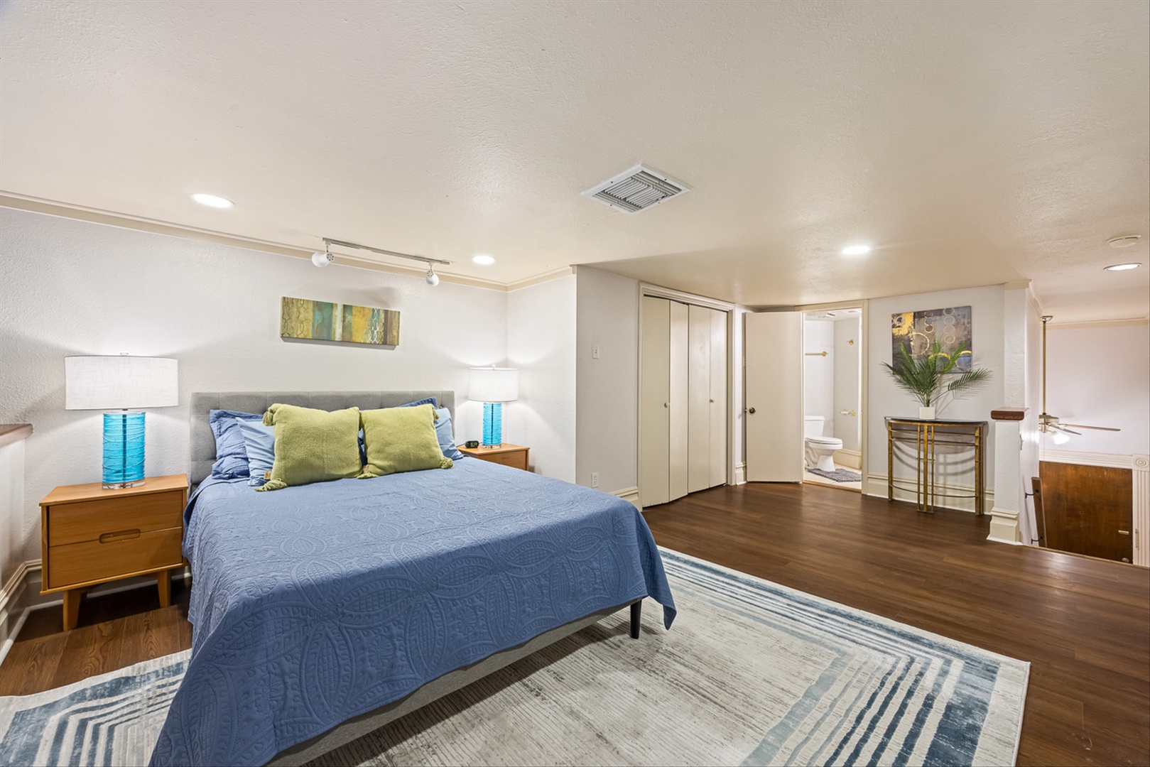 Spacious bedroom with comfy bed and private en-suite bath.