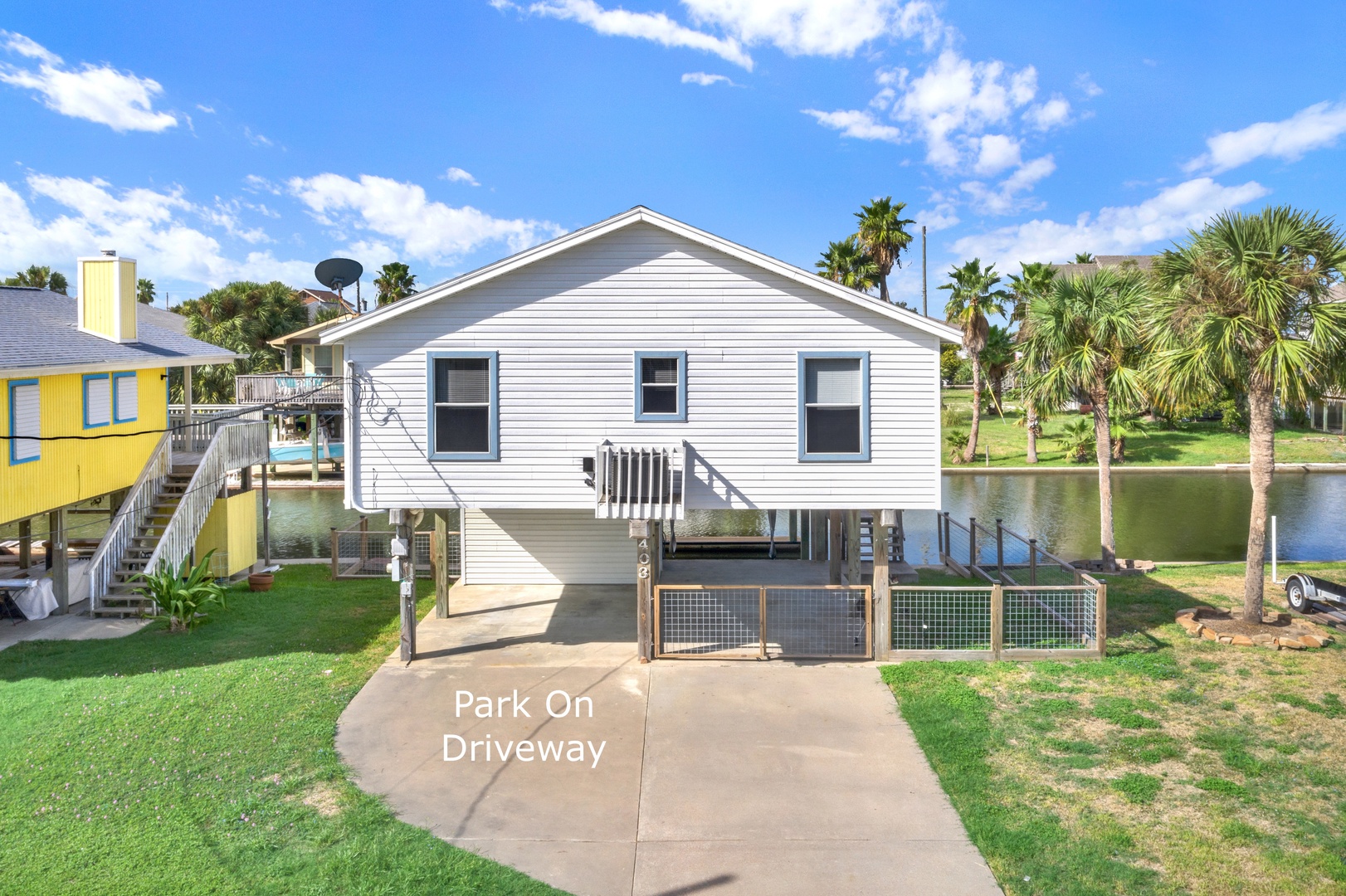 This coastal property sits along a canal with convenient parking and waterfront access. Enjoy the tropical surroundings, nearby lake, and lush greenery framing your getaway.