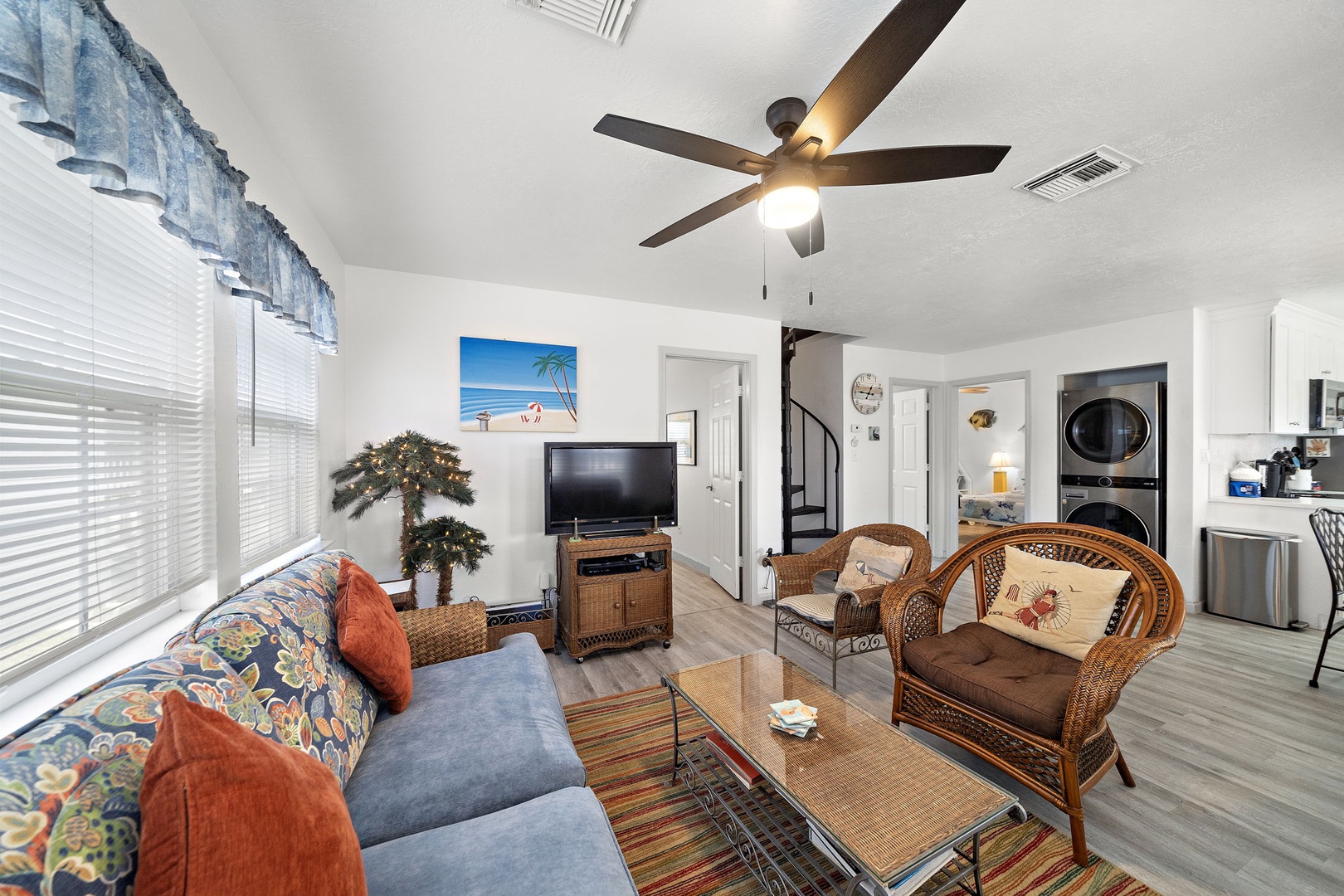 Unwind in your bright, coastal-themed living space where beach vibes meet comfort. Sink into the plush blue sofa, catch up on shows, and enjoy the open flow to your fully equipped kitchen and laundry.