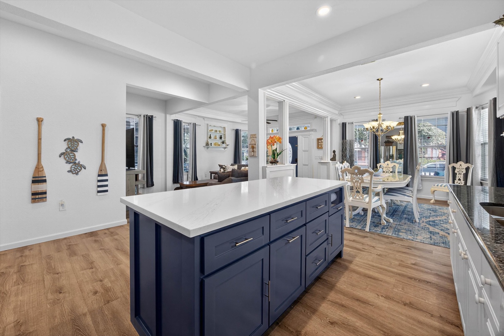 Your gourmet kitchen features a stunning navy island with marble countertops, perfect for cooking memorable meals together.