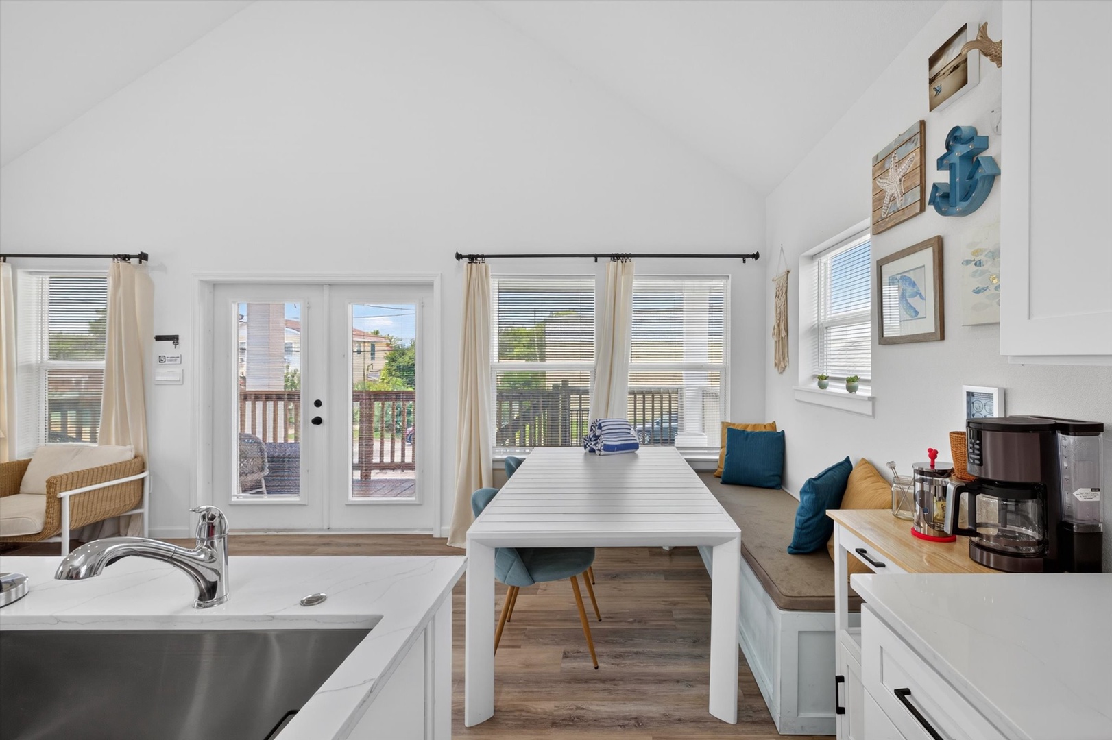 Open living space with nautical décor and deck.