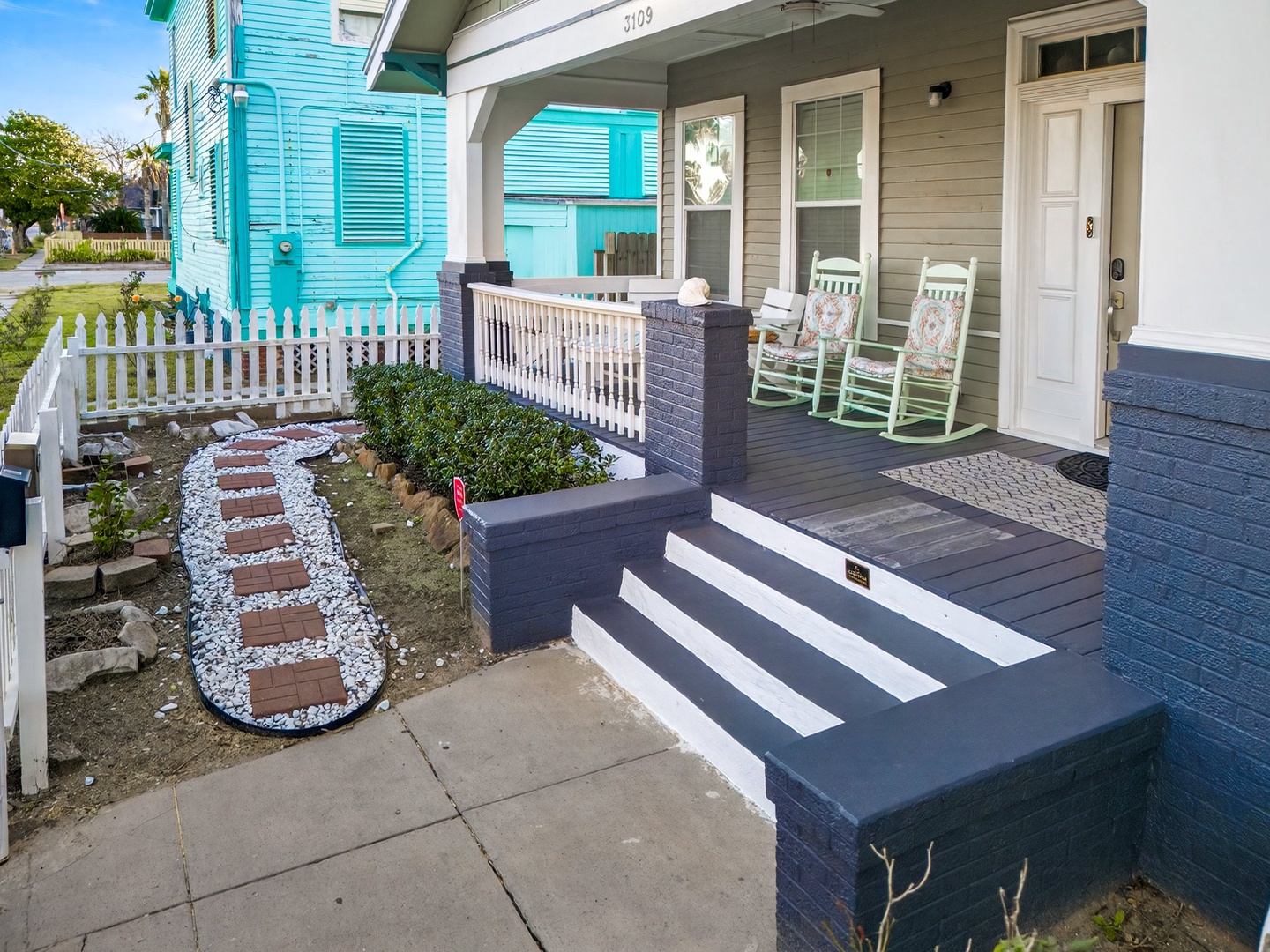 Charming front porch with rocking chairs where you can unwind and watch the neighborhood come to life each morning.
