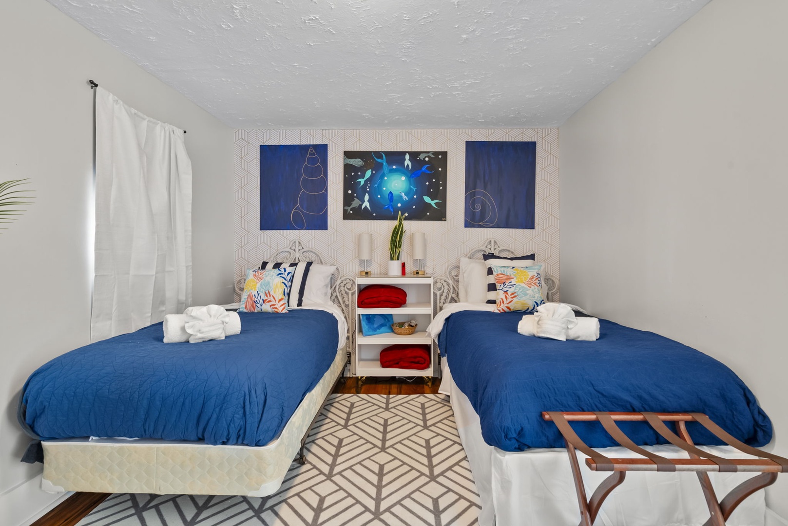 Twin bedroom with space-themed art and homey touches.