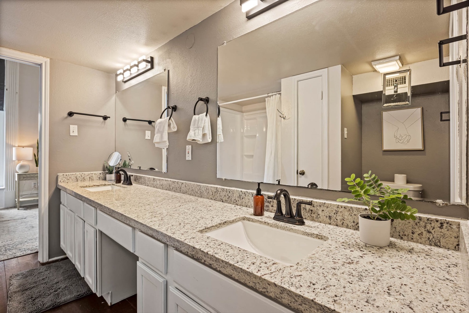 Dual-sink master bathroom with granite and modern style.