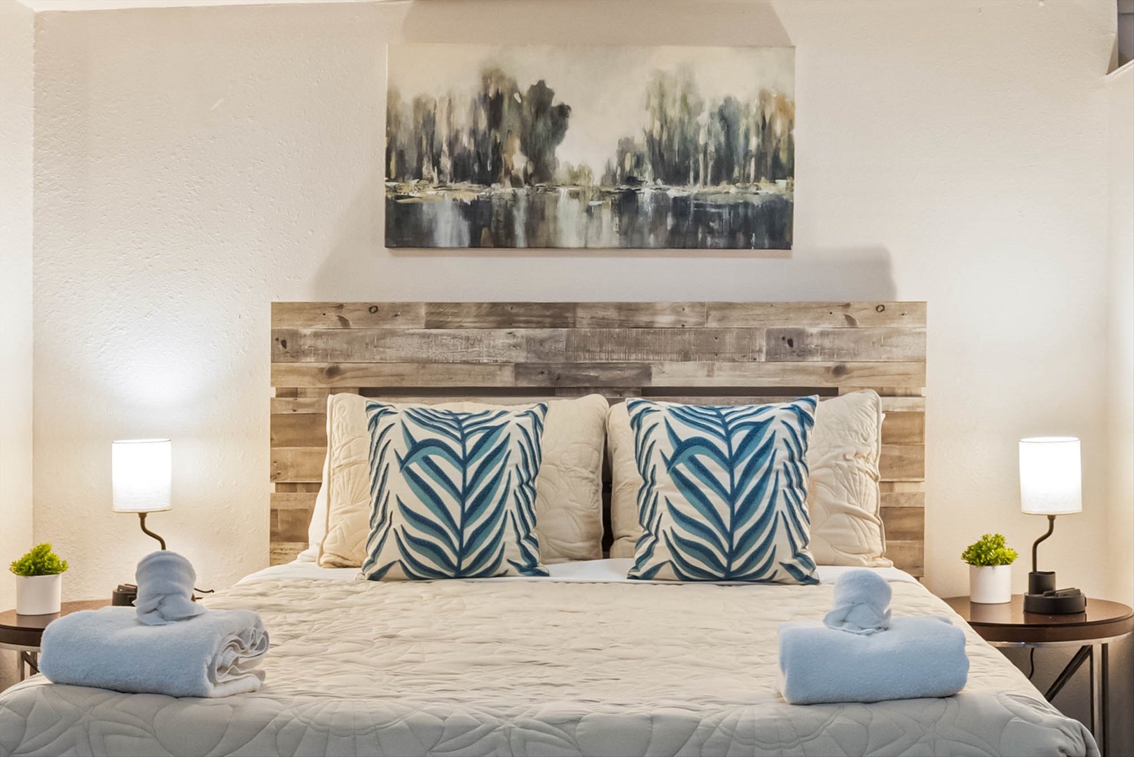 Beautifully styled bedroom with blue linens and rustic charm.