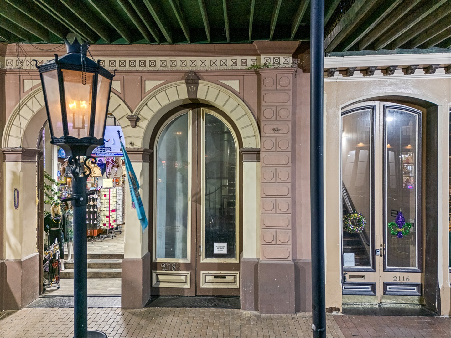 Elegant historic entrance with arches and classic street lights.