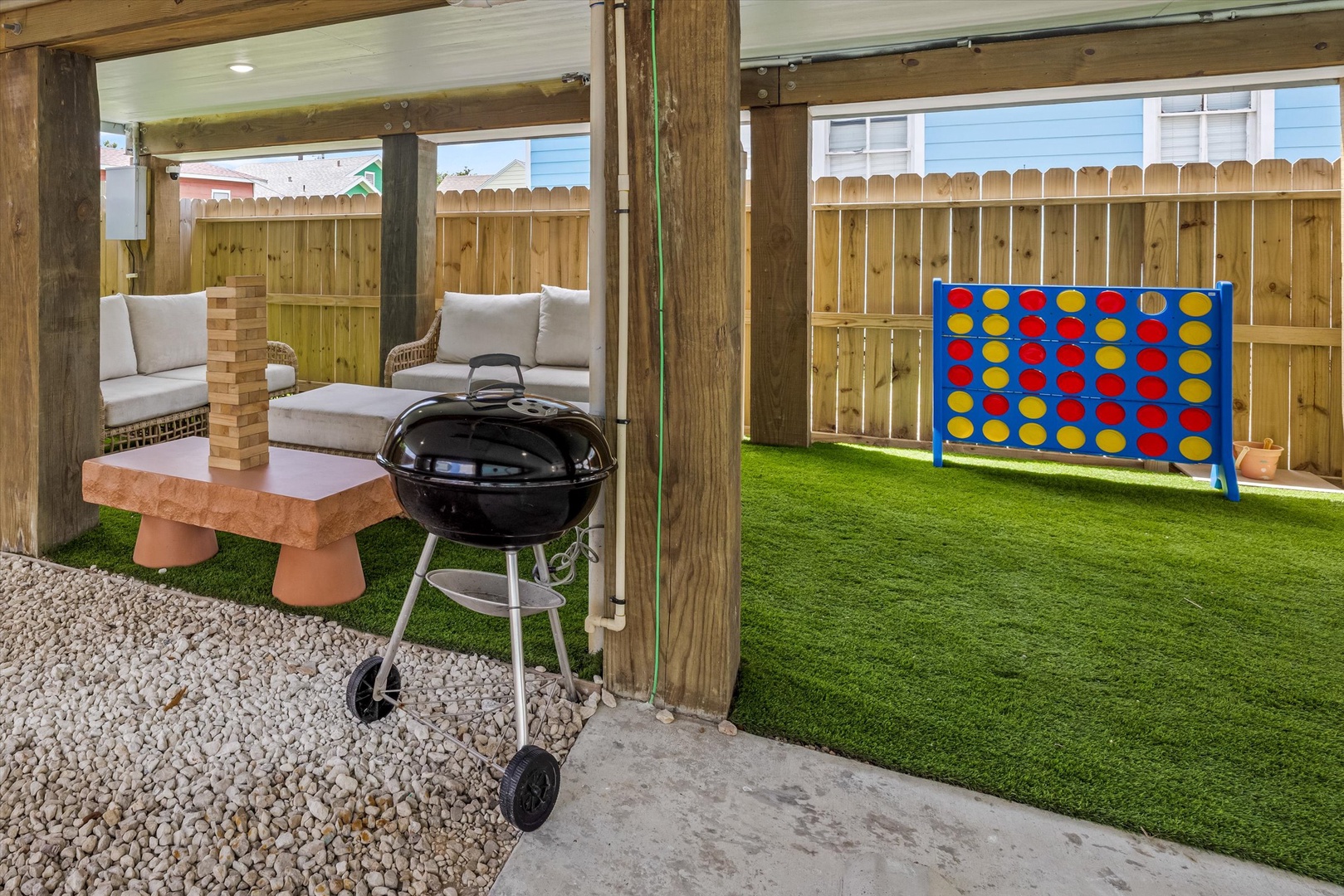 Backyard fun with grill, pergola, and giant Connect Four.