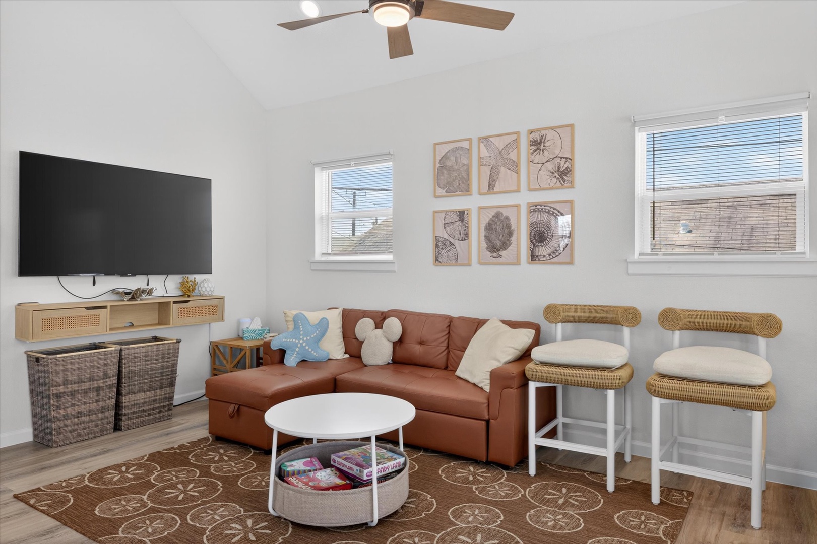 Bright living room with sectional and coastal charm.