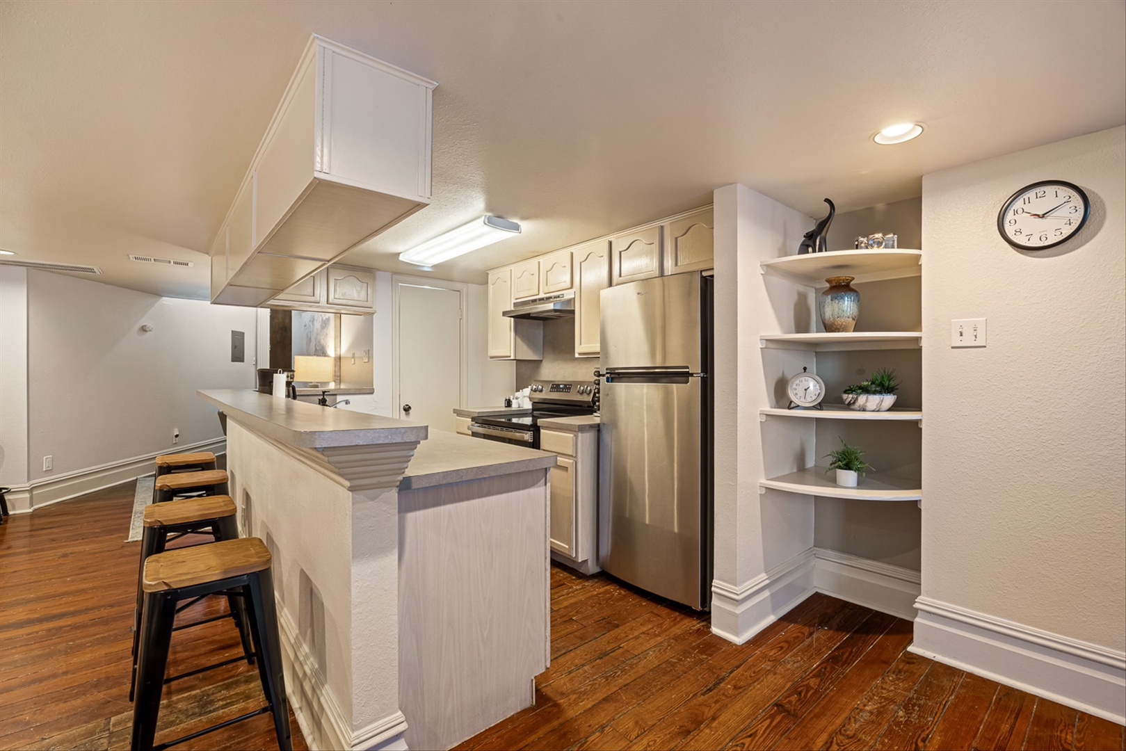 Fully equipped kitchen with counter space and bar seating.
