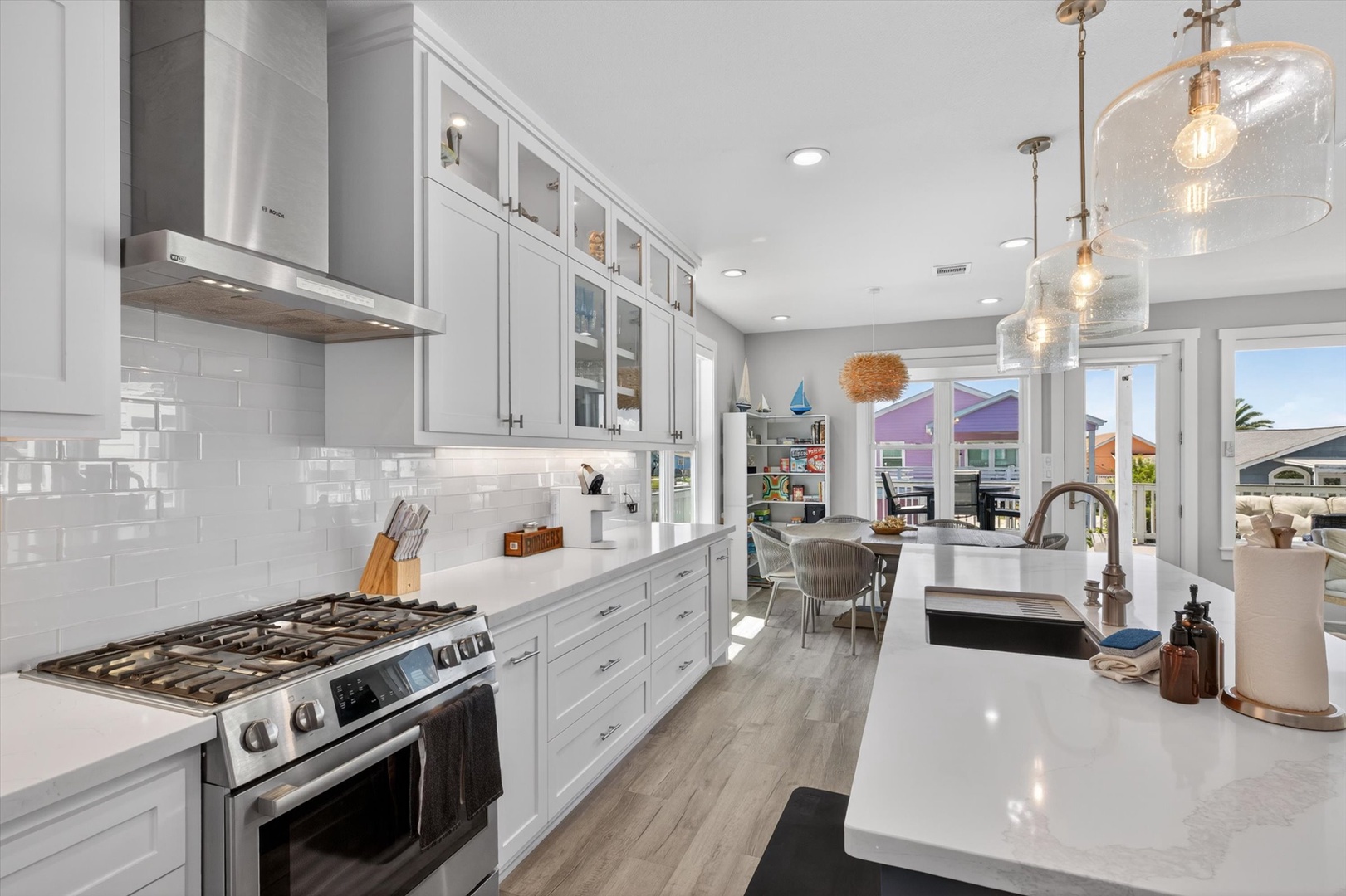 Elegant kitchen with stainless appliances and white cabinets.