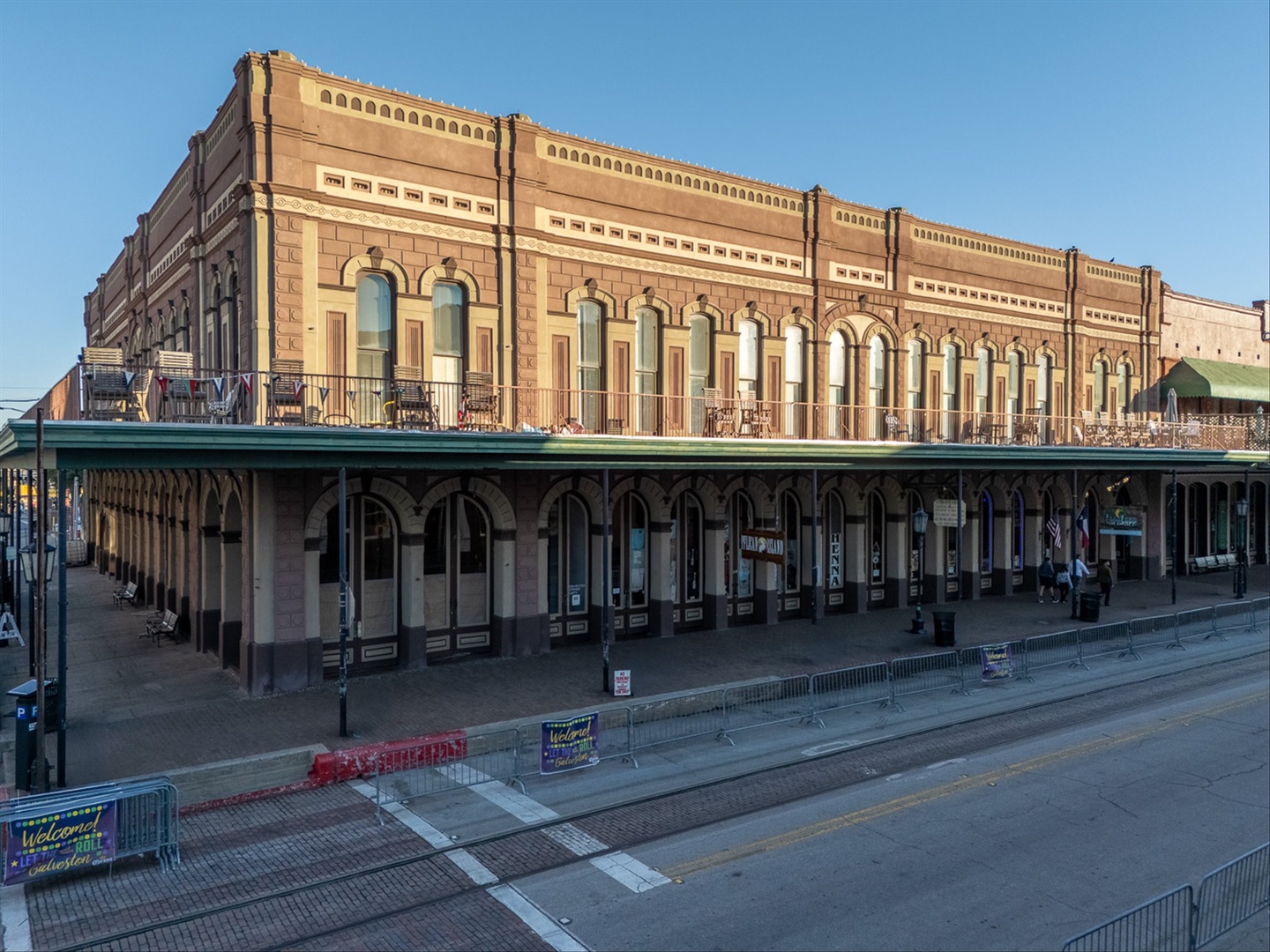 Brick building with covered walkways and arched details.