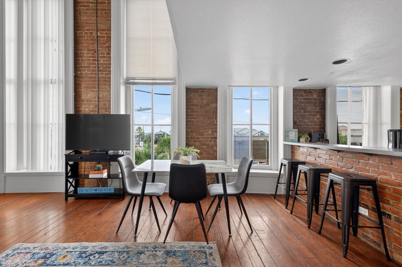 Modern dining area with brick walls and natural light.