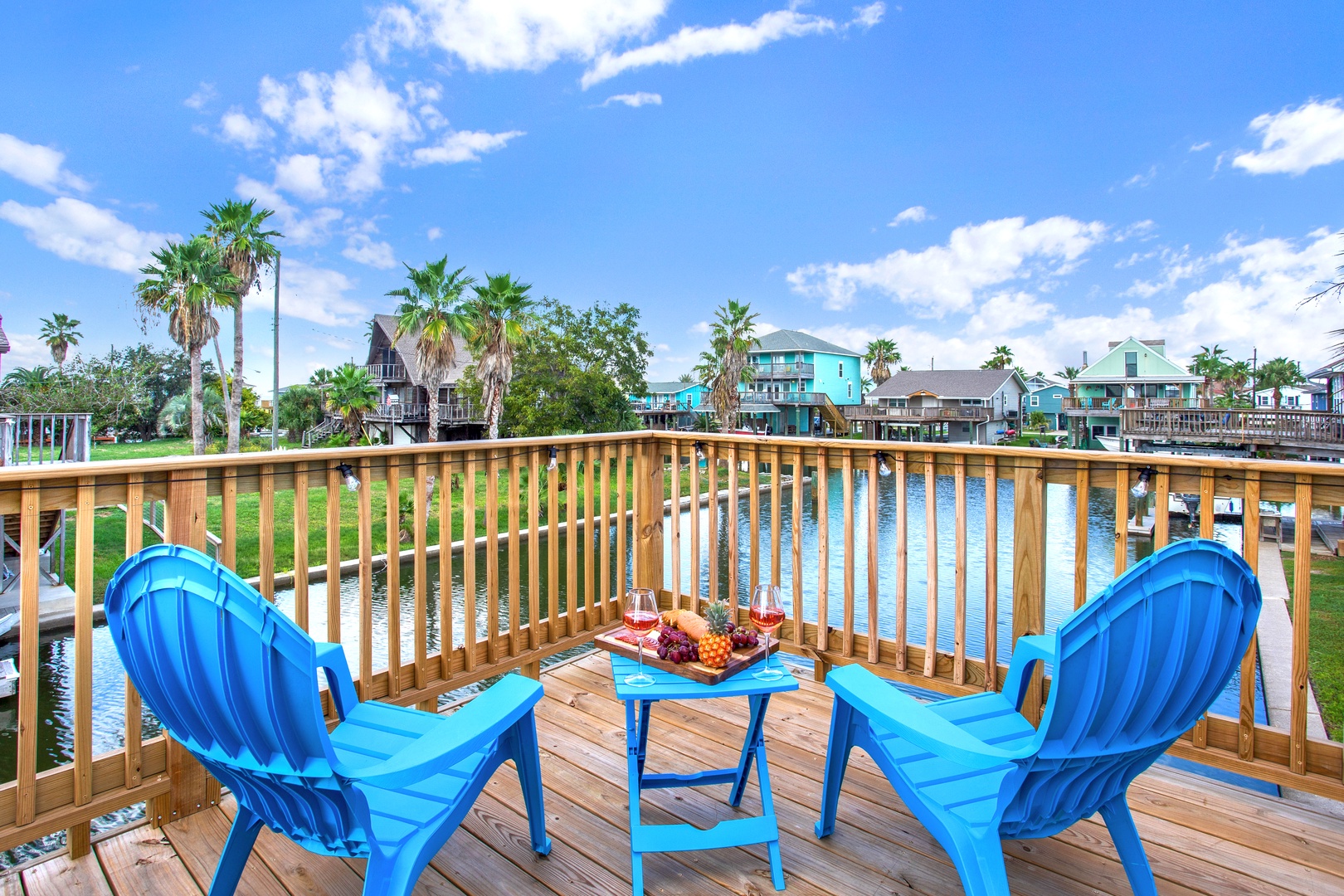 Picture yourself enjoying morning coffee on your private waterfront deck, with vibrant turquoise chairs and tranquil canal views stretching toward palm-lined shores.