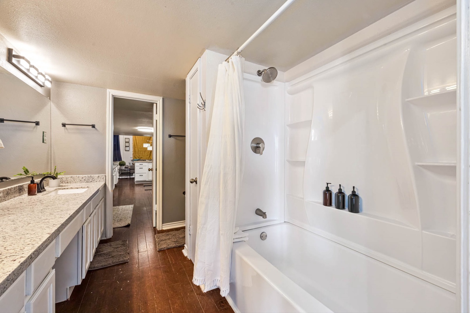 Bathroom with soaking tub, refreshing shower, and granite counters.