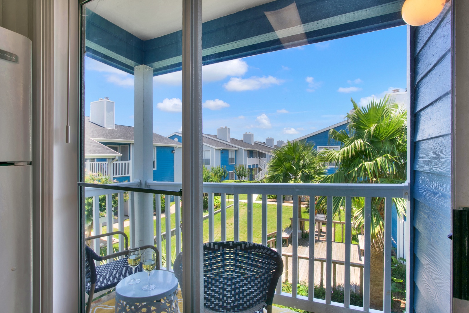 Private balcony views with sunny skies & palm trees