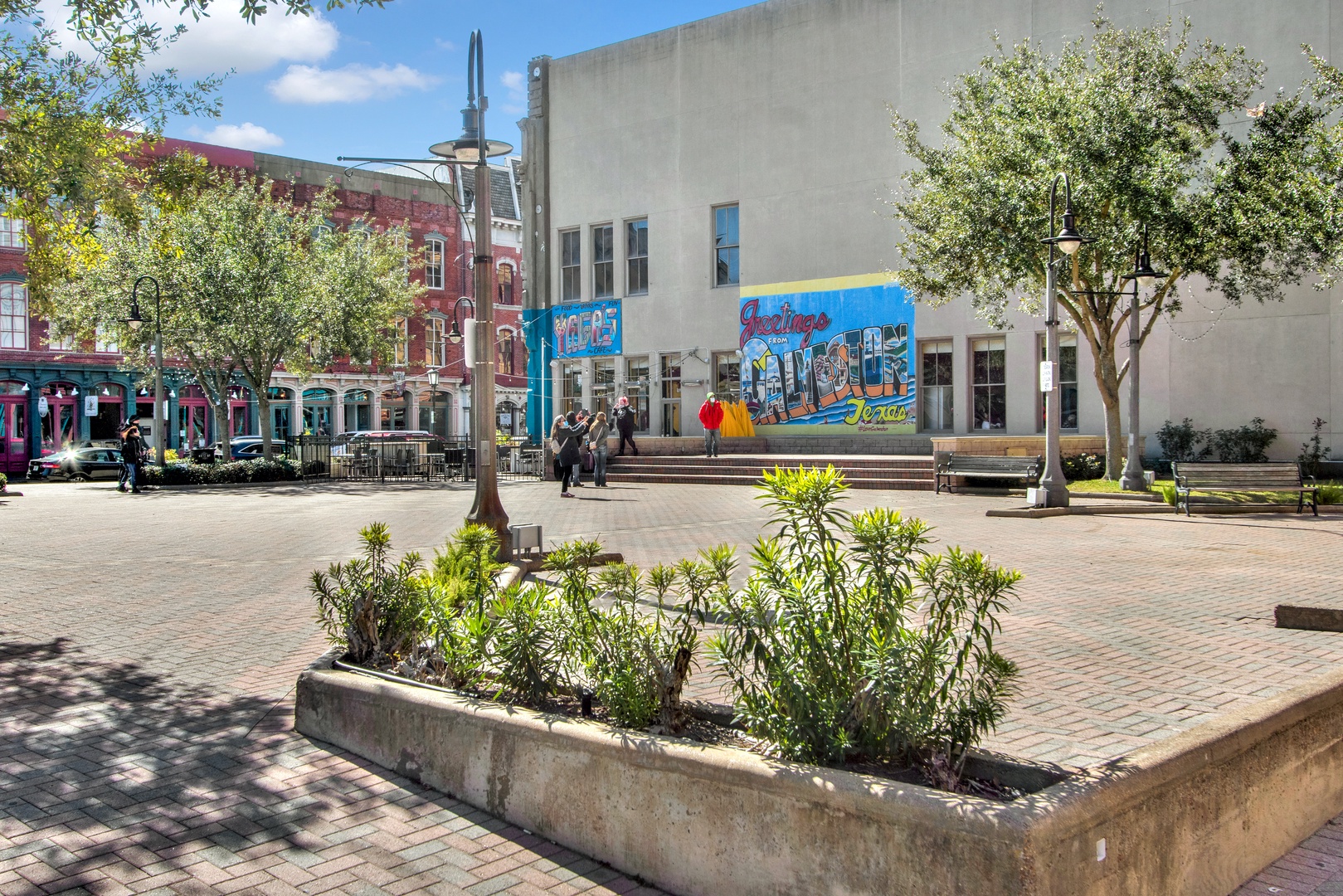 Historic Strand with shops and tree-lined streets.