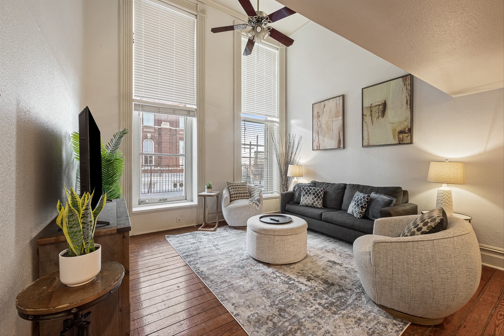 Modern open living space with kitchen and comfy seating.