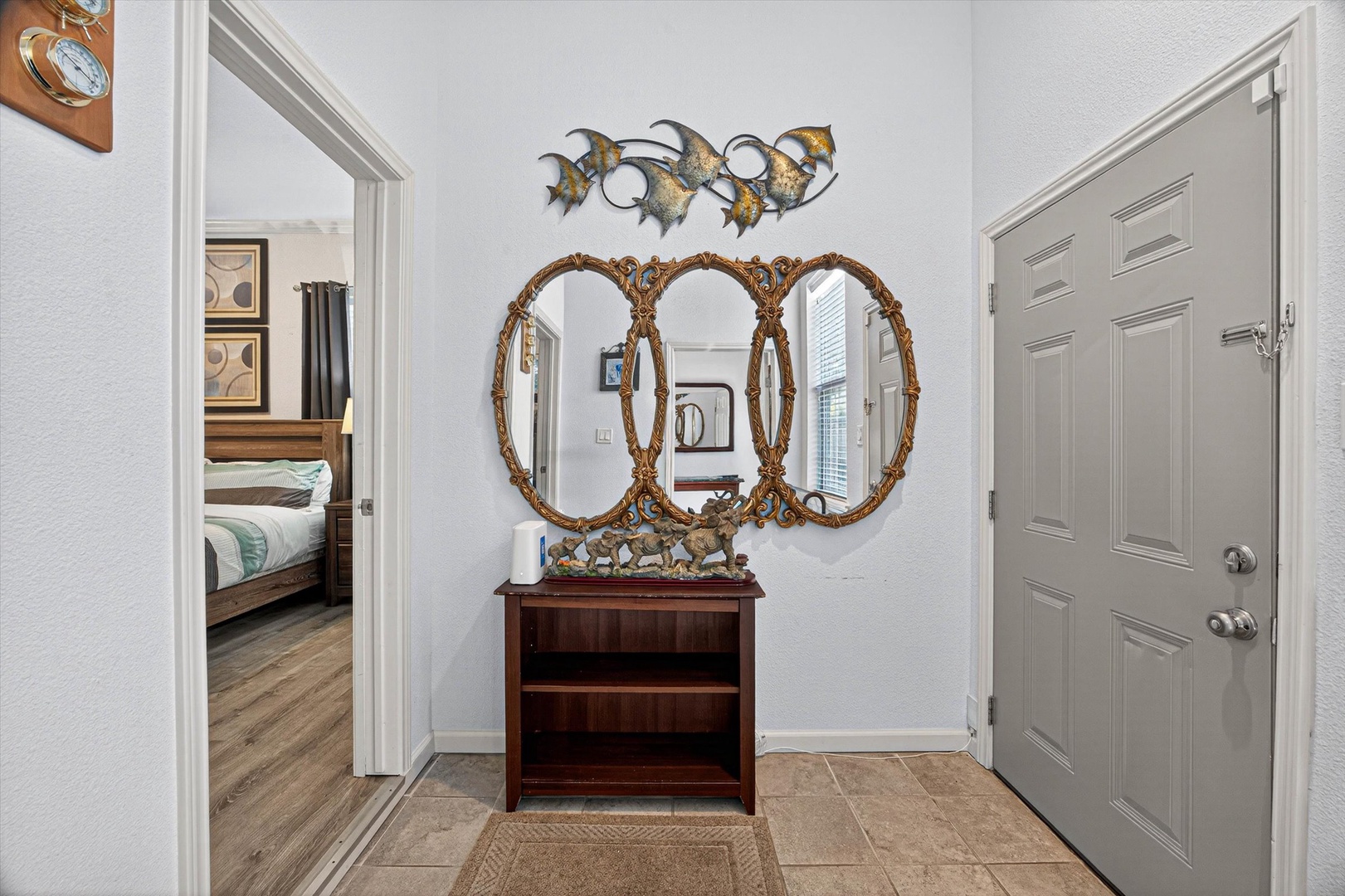 Step into your elegant laundry room, where decorative mirrors and coastal artwork create a welcoming first impression for your vacation getaway. Step outside for picnic table and grill.