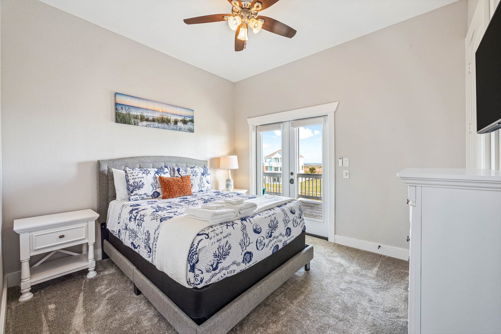 Comfortable bedroom with plush bed and balcony access.