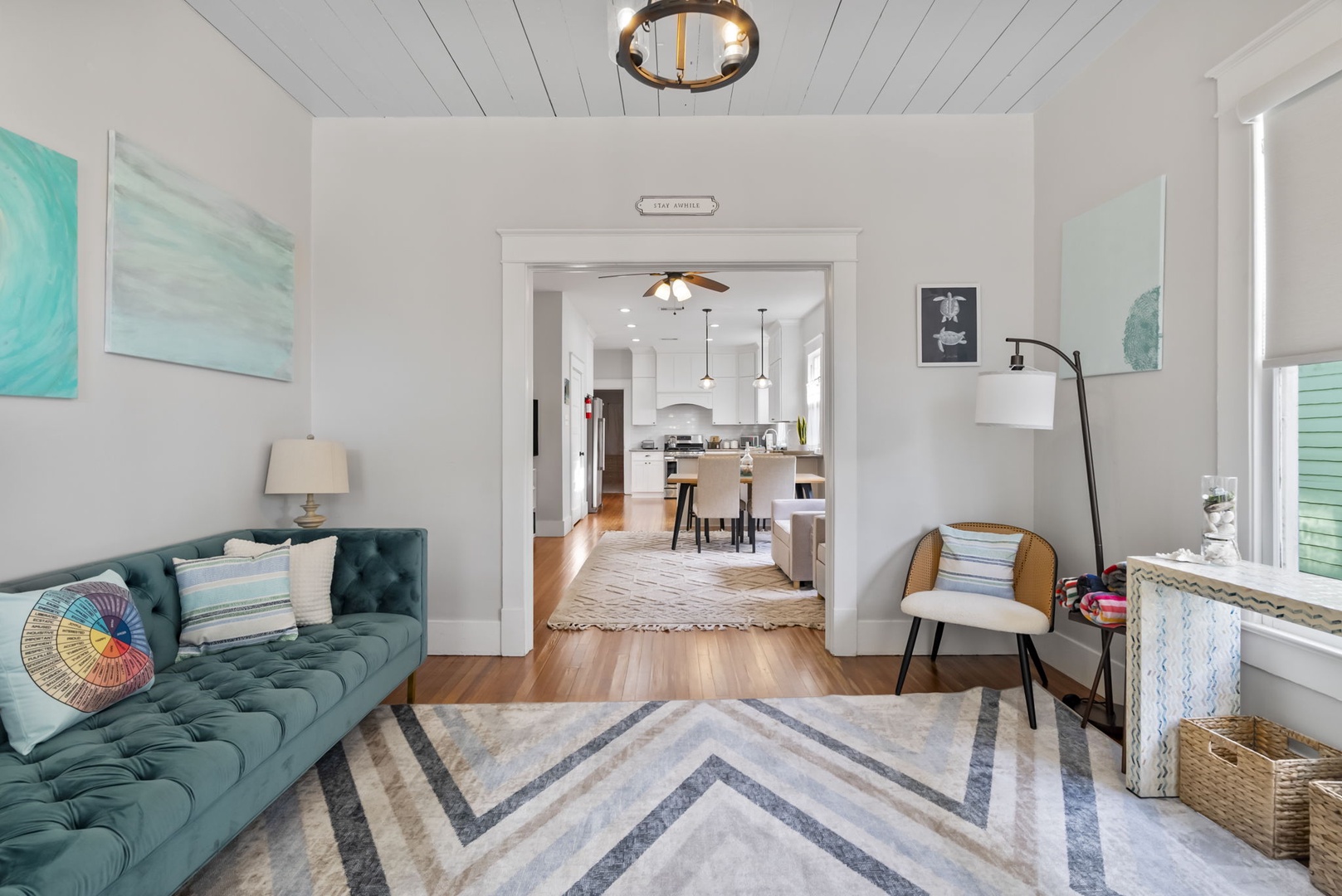 Plush tufted sofa in a bright coastal space with wood floors.