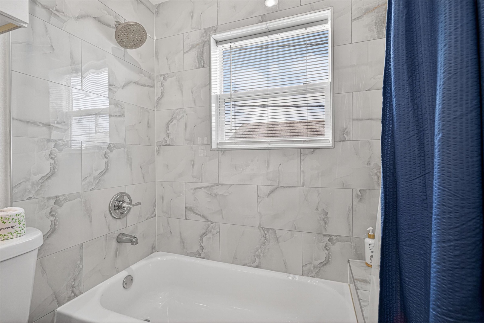 Marble bathroom with soaking tub and rainfall shower