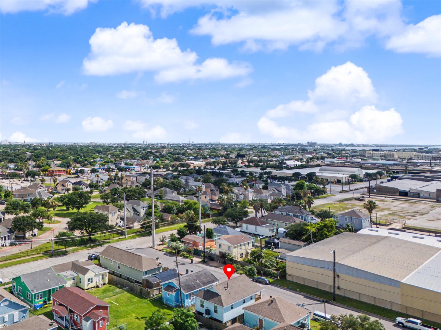 Property aerial view in a green residential neighborhood.