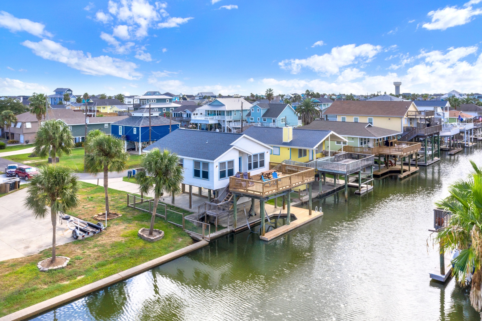 A vibrant waterfront neighborhood featuring your home with private dock along a peaceful canal.