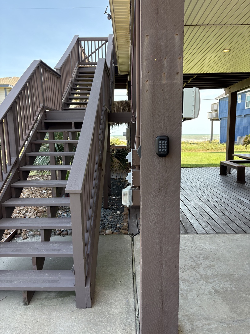 Property entrance with secure keypad access and modern staircase leading to your home away from home.