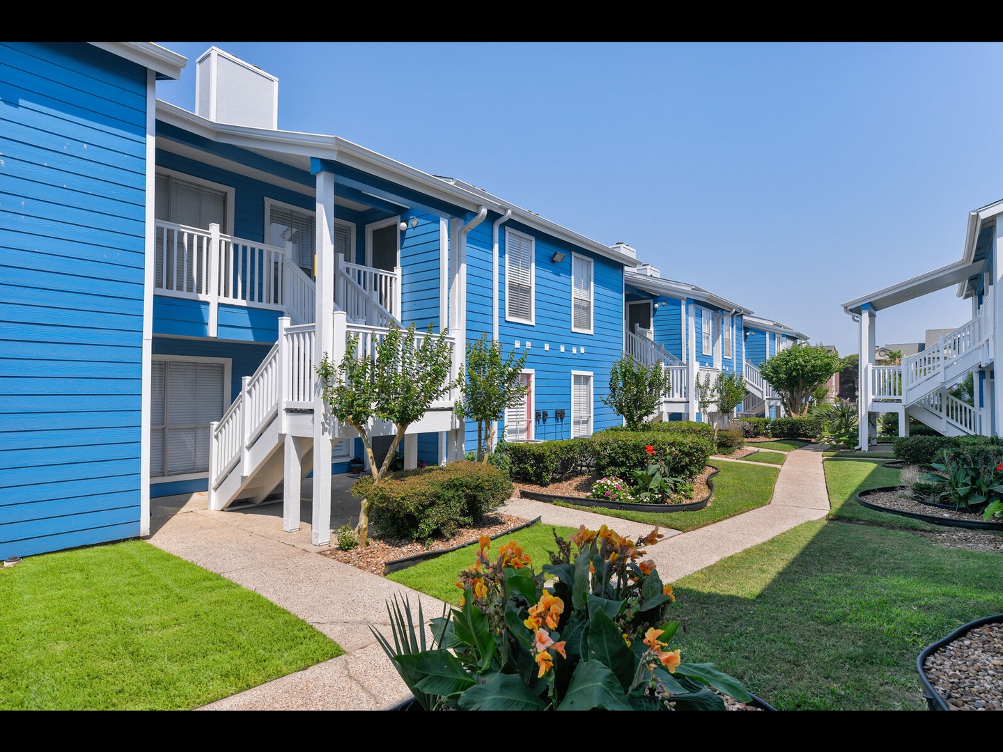 Beautiful blue buildings with garden paths