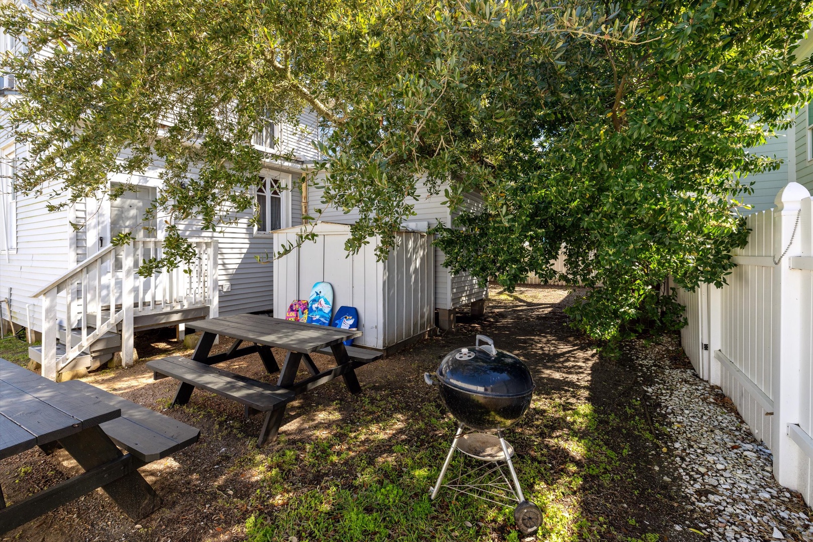 Fire up the grill and enjoy your private outdoor space with picnic table seating under the shade of mature trees - perfect for memorable meals al fresco.
