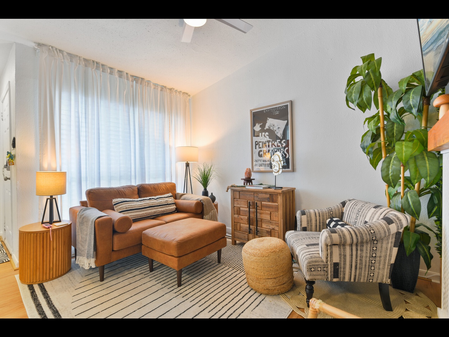 Cozy living space with leather seating & greenery