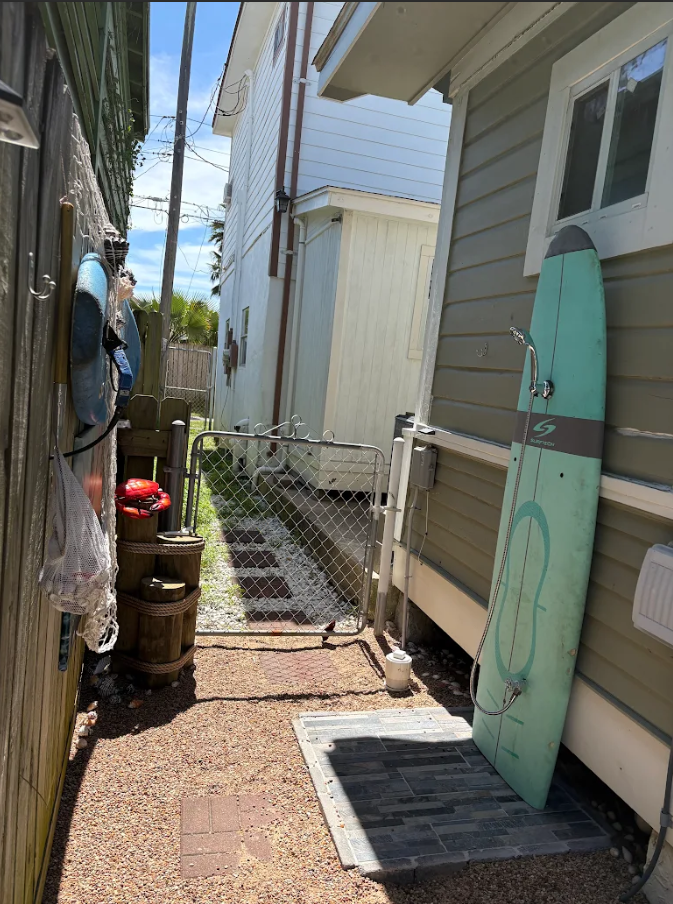 Side outdoor shower for easy beach rinses.