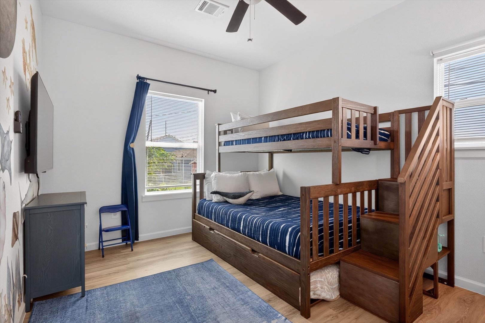 Fun bunk room with ceiling fan and cozy sleeping space.