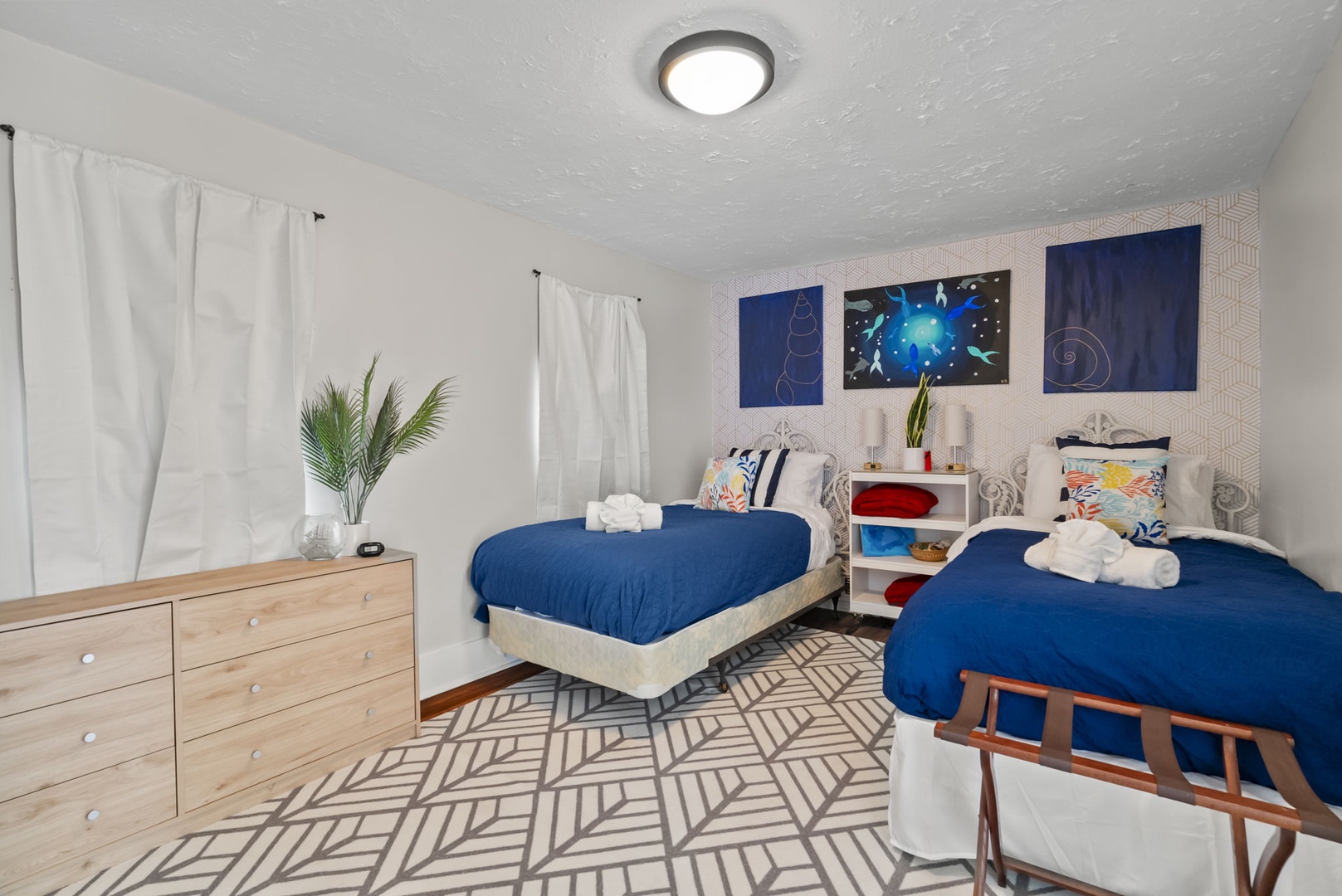 Cozy twin bedroom with space art and thoughtful touches.