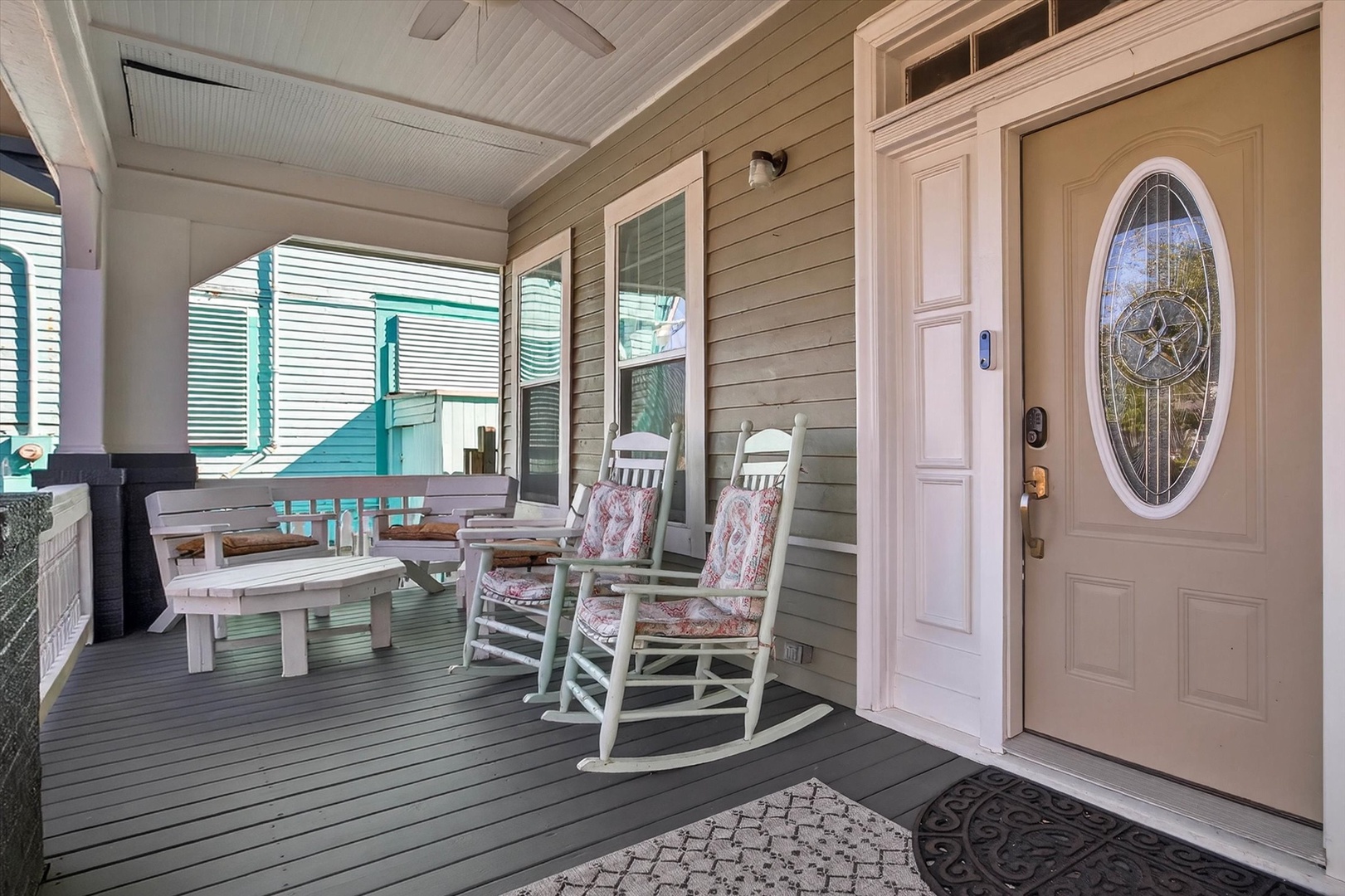 Settle into your cozy rocking chairs on this welcoming covered porch, perfect for morning coffee or evening relaxation.