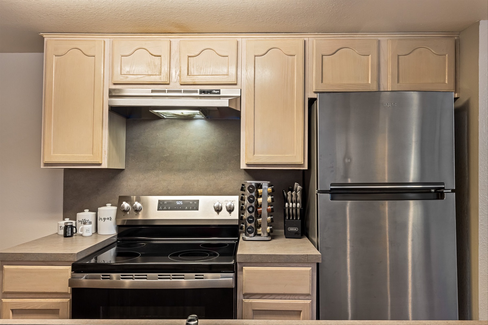 Full-size stainless steel appliances for easy cooking.