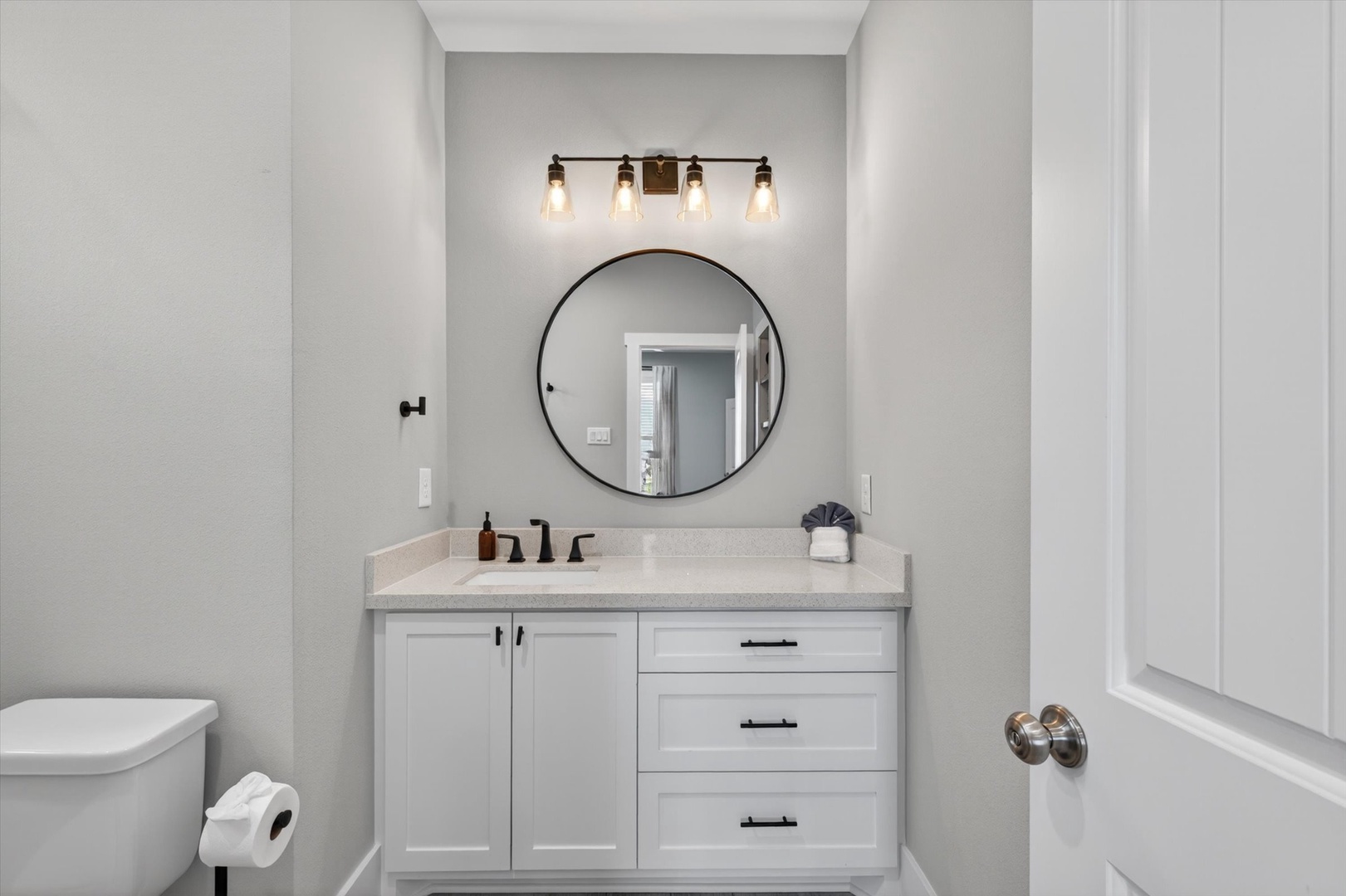 Private bath with elegant vanity and stylish mirror.