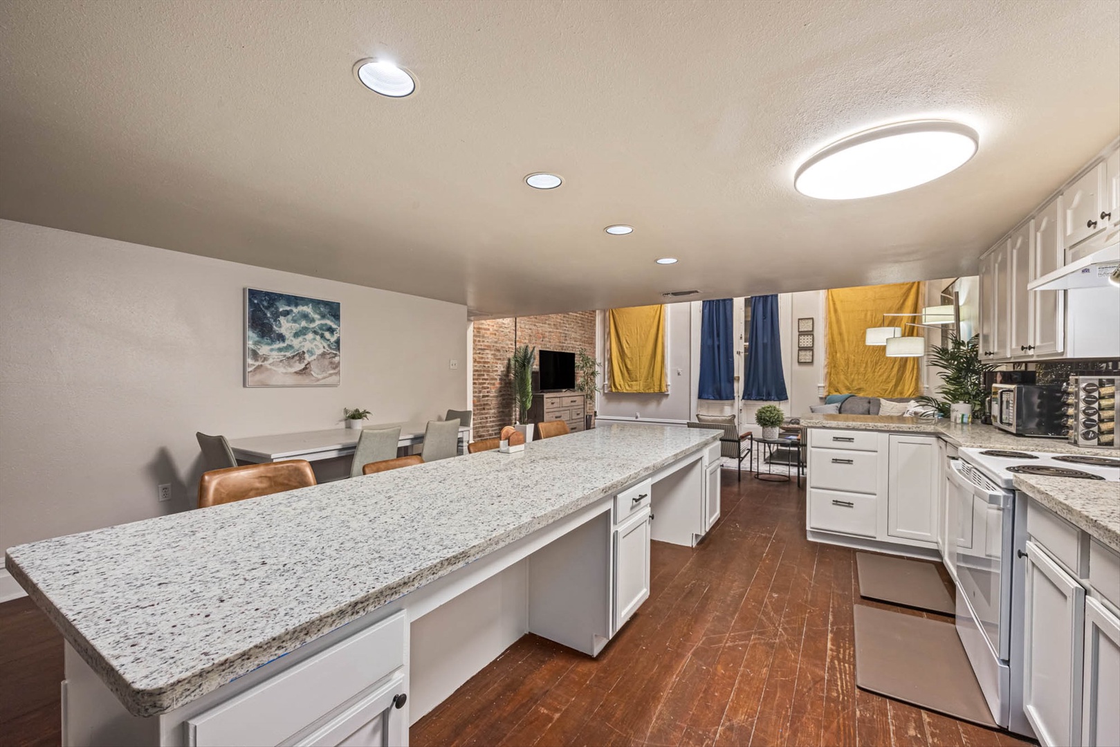 Spacious granite kitchen opening to bright living area.