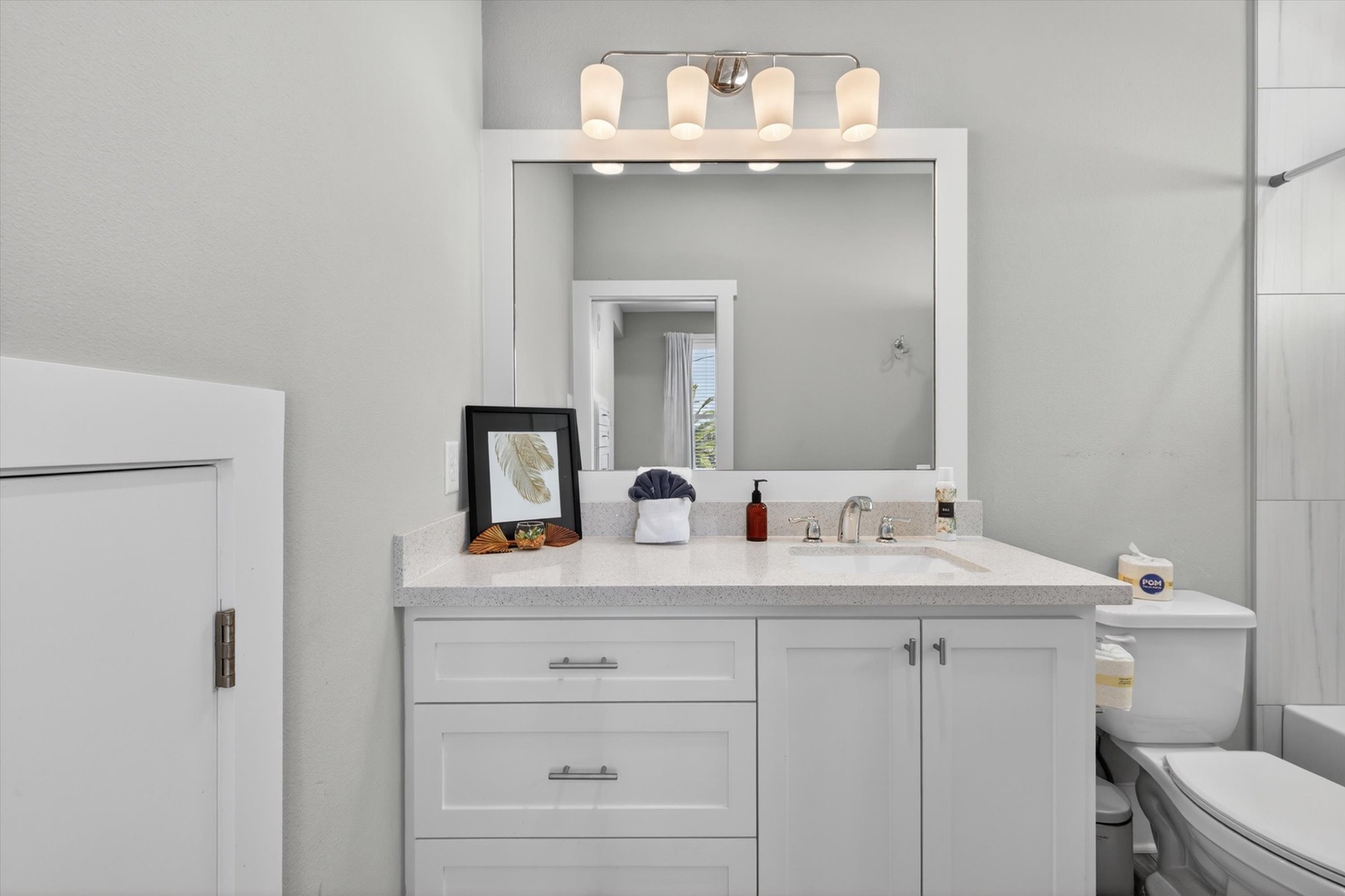 Freshen up in a pristine bath with modern touches.