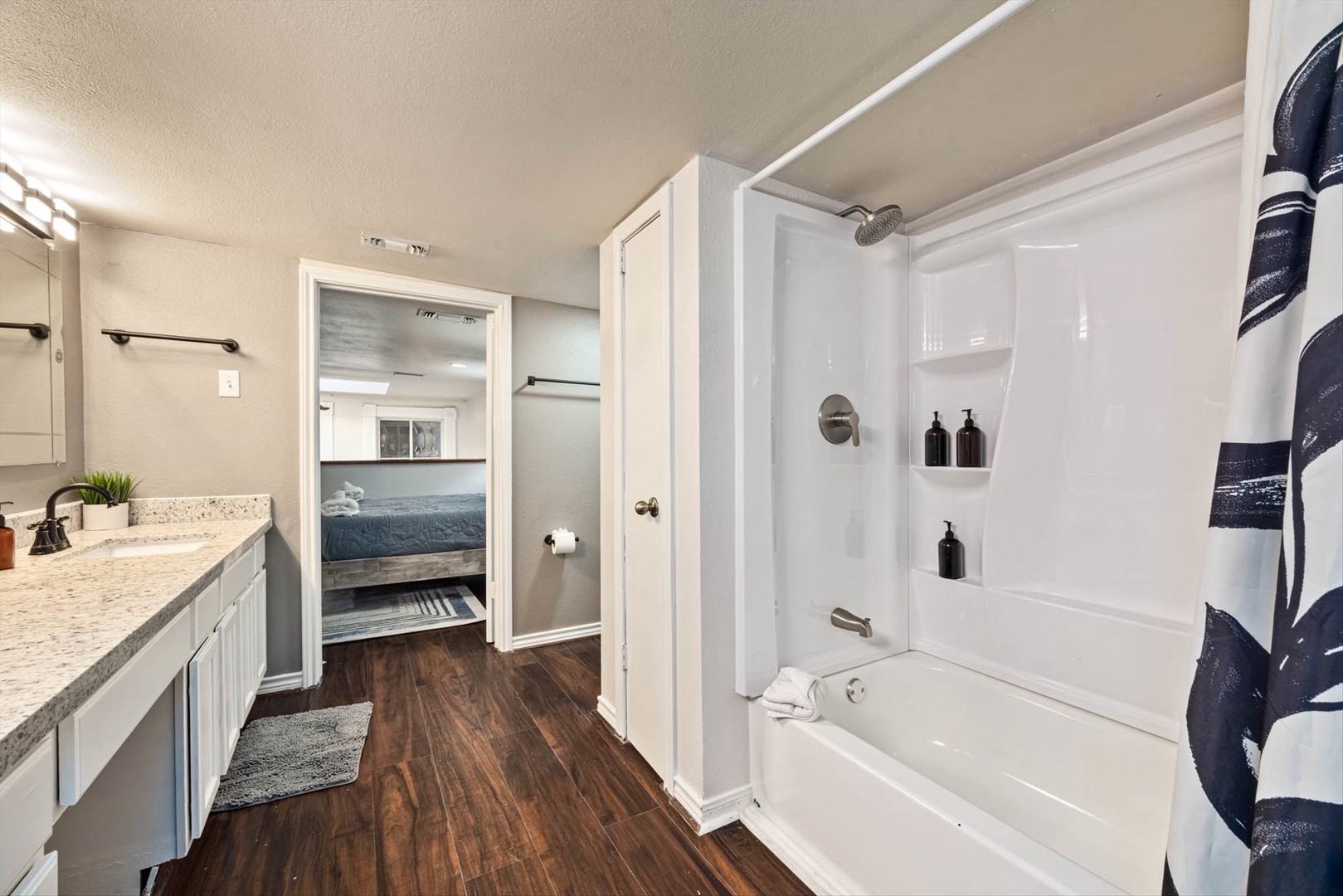 Modern bathroom with shower-tub combo and thoughtful touches.