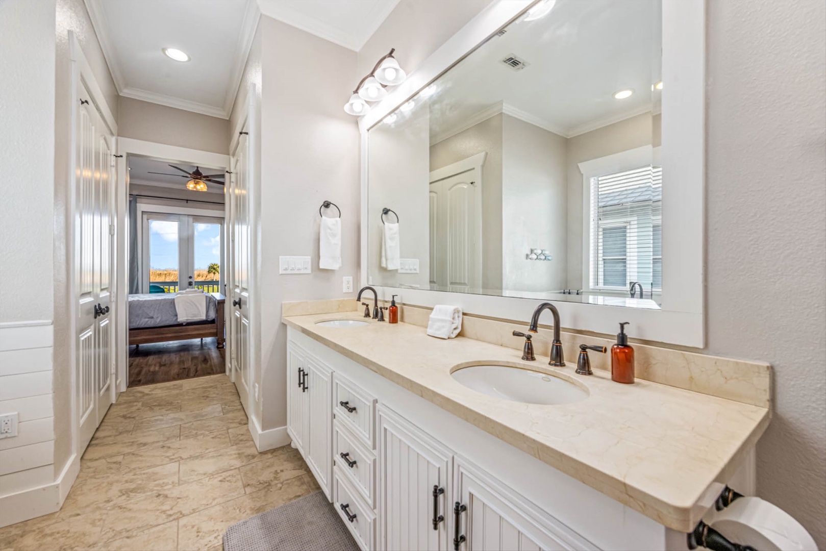 Step into your elegant bathroom featuring dual vanities, marble countertops.