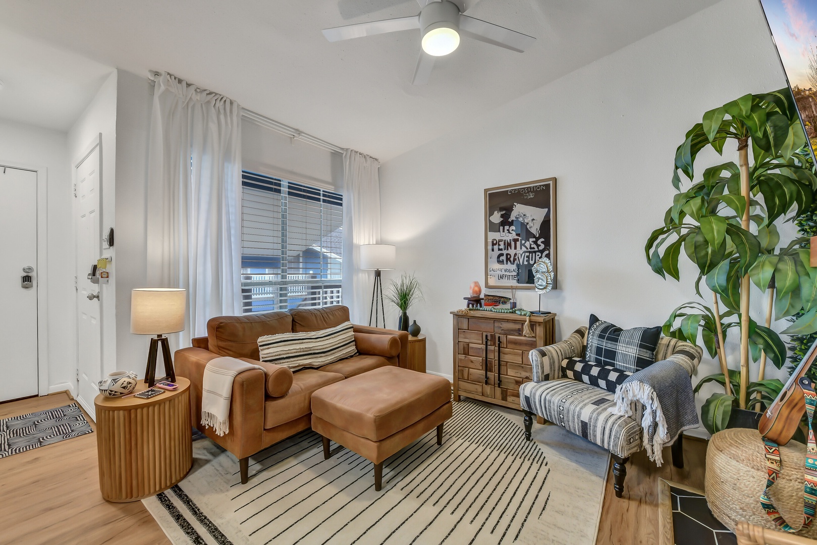 Bright living room with vaulted ceilings & leather sofa