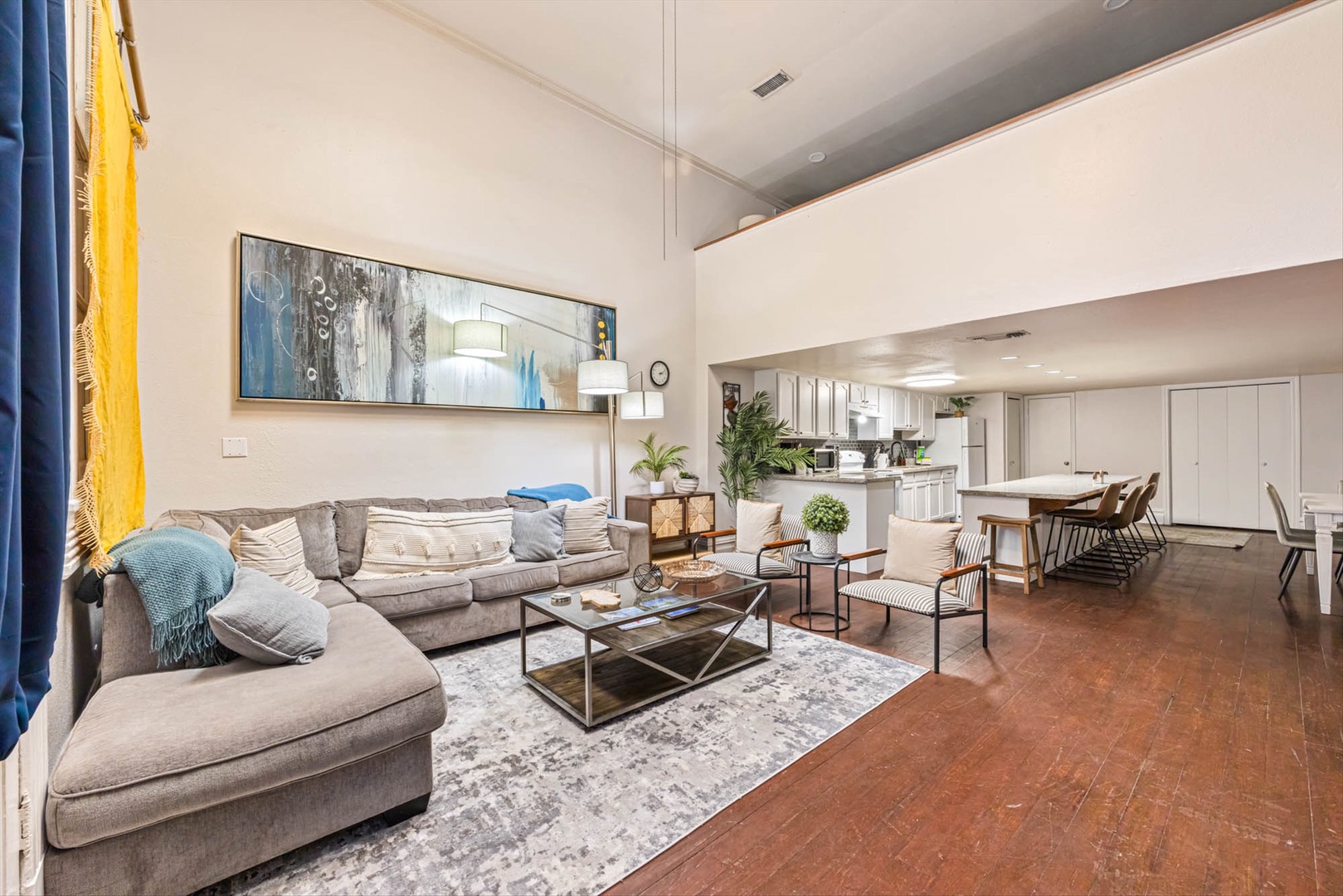 Airy living space with plush seating and modern art.