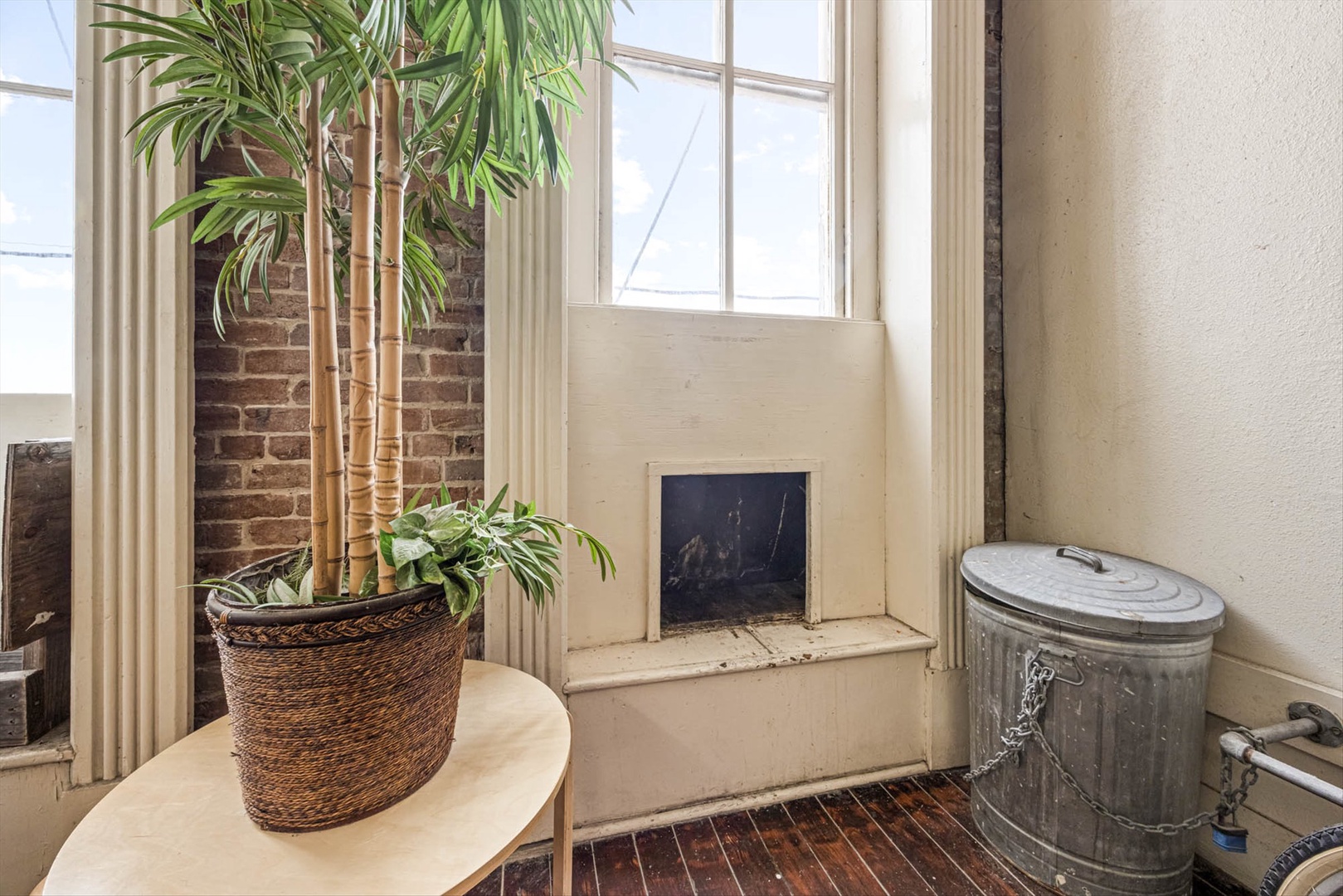 Charming cozy corner with fireplace and sunlit windows.