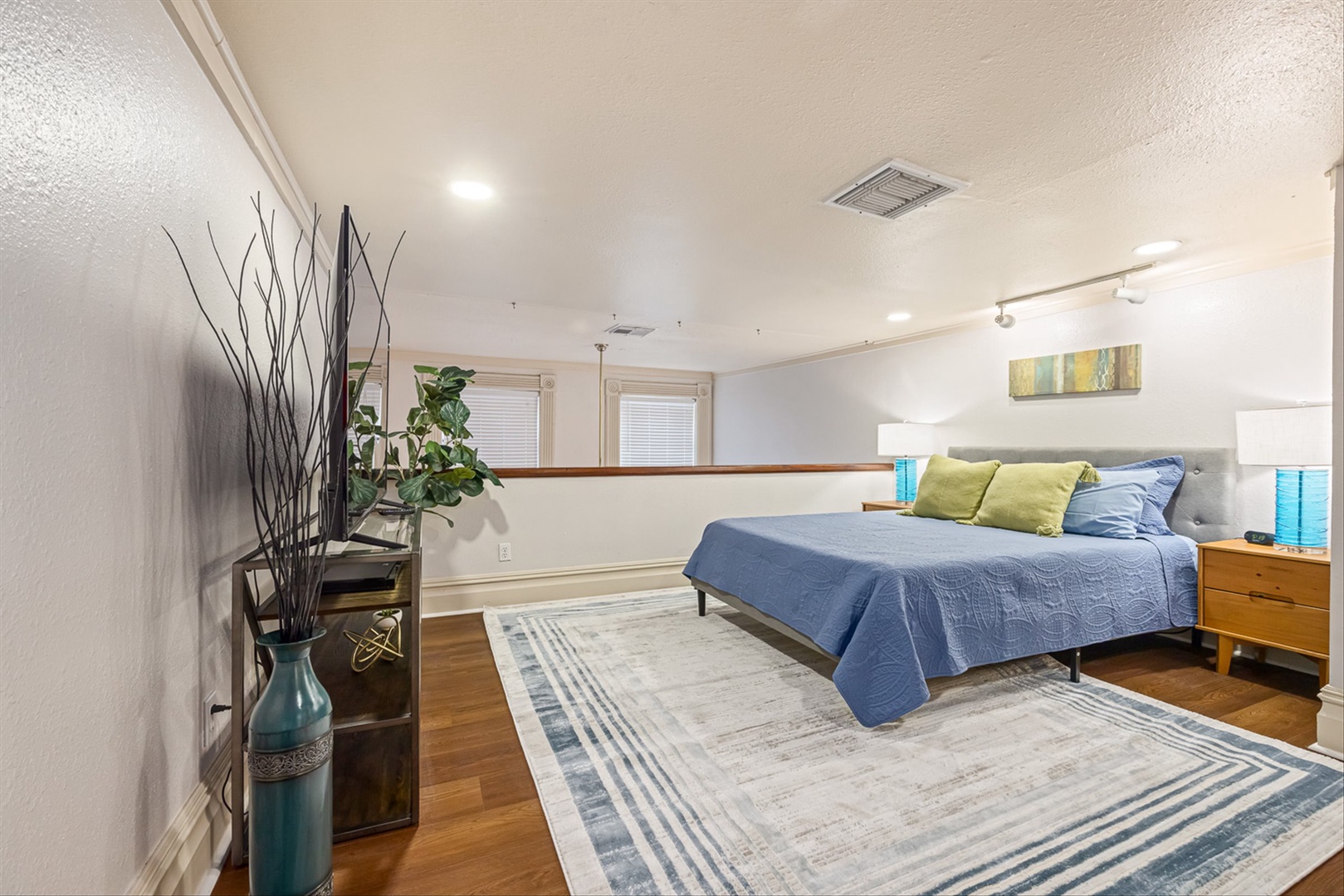 Bedroom suite with hardwood floors and private bathroom.