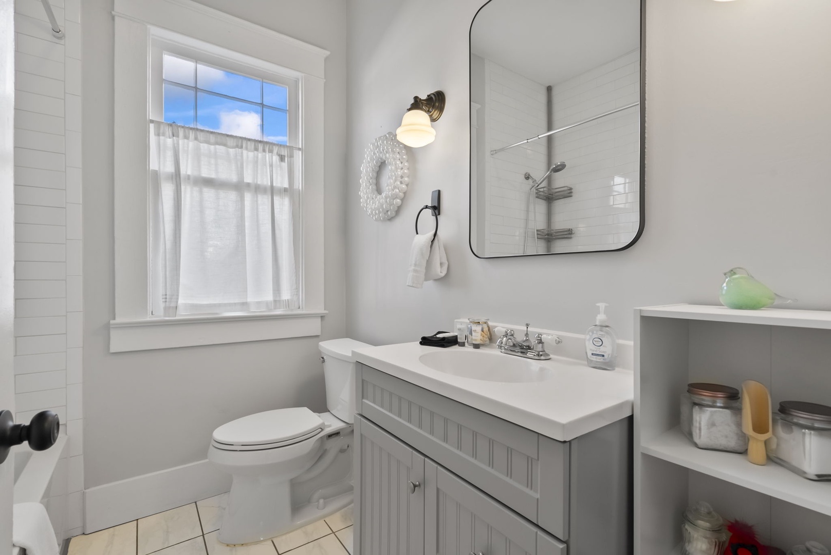 Bright, charming bathroom with natural light and vanity.