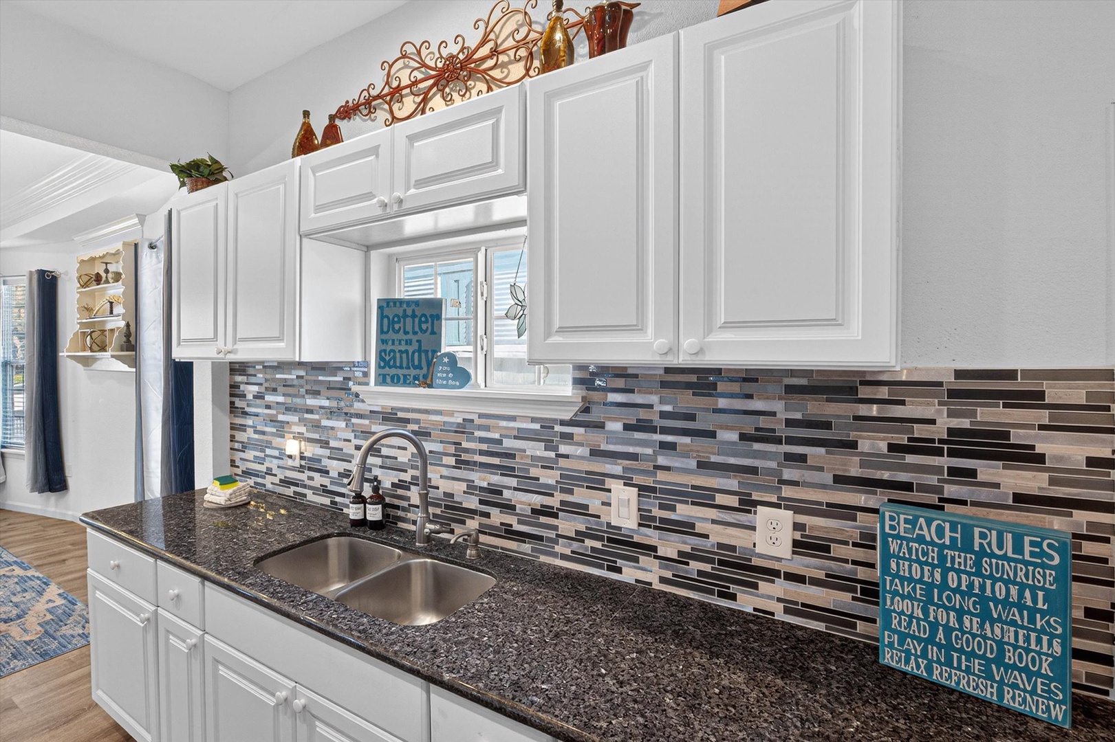 Your fully equipped kitchen features granite countertops, modern appliances, and a stunning mosaic backsplash for all your culinary adventures.