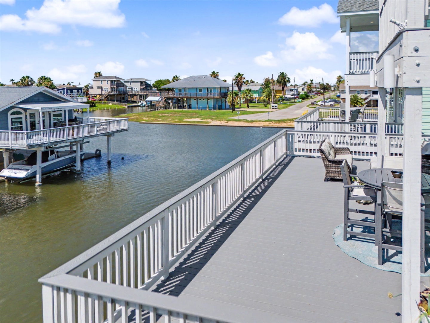 Waterfront canal home with palm trees and dock access
