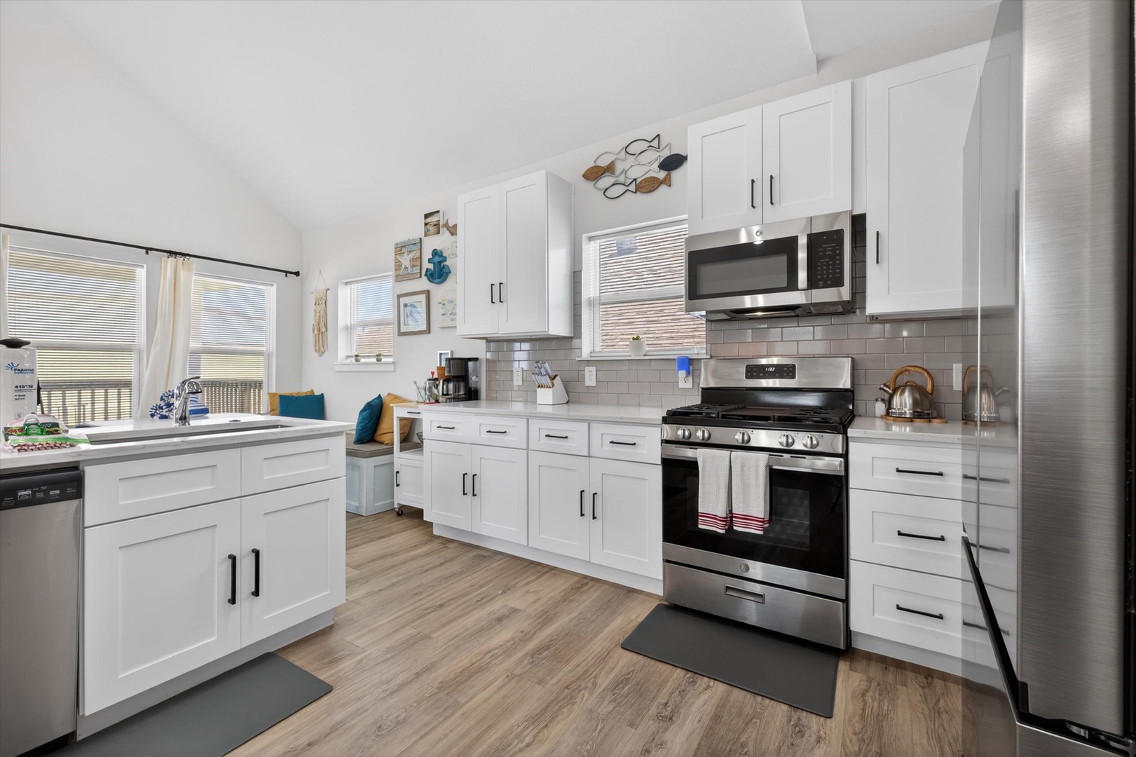 Bright kitchen with stainless appliances and cozy nook.