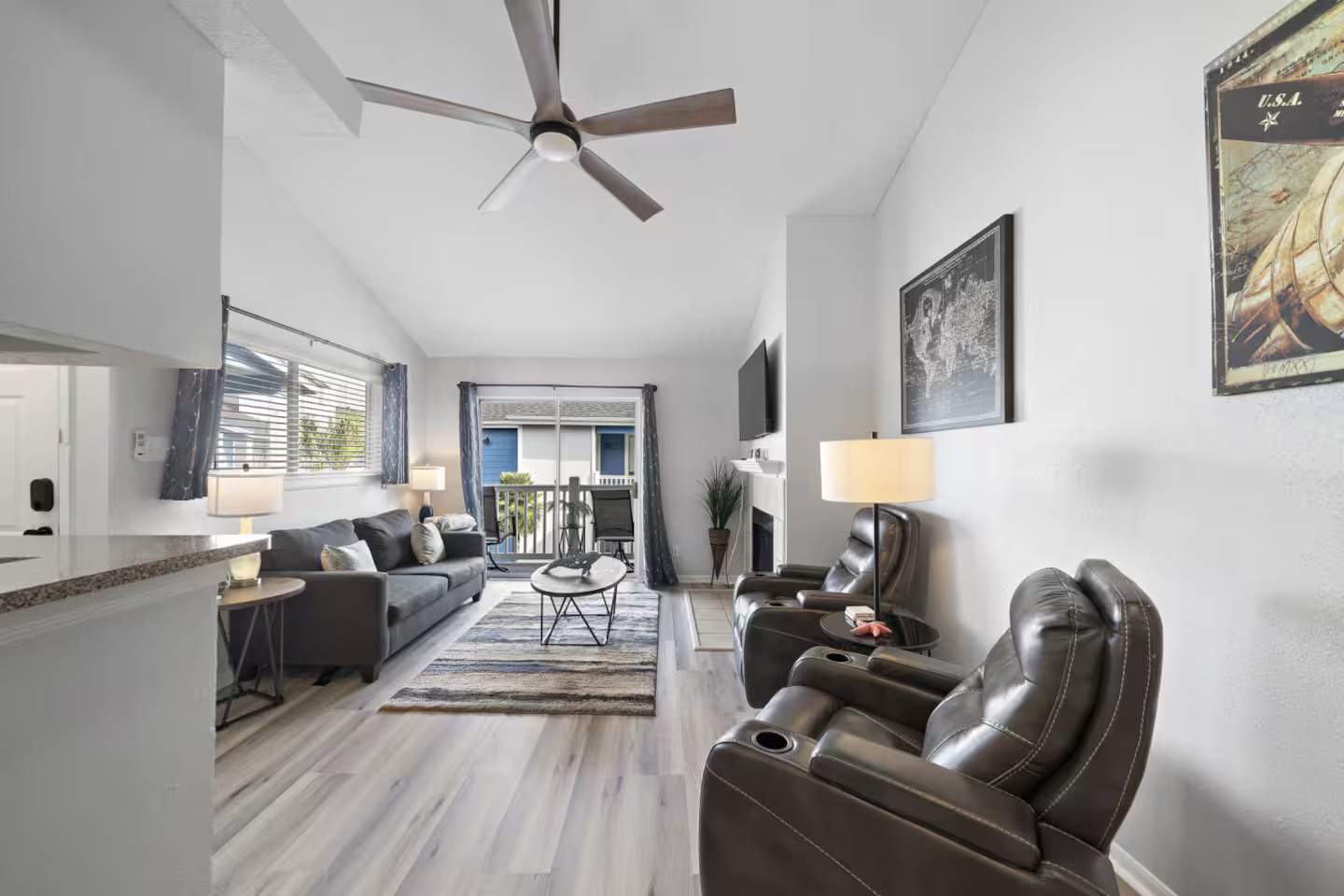 Bright living room with vaulted ceilings & balcony